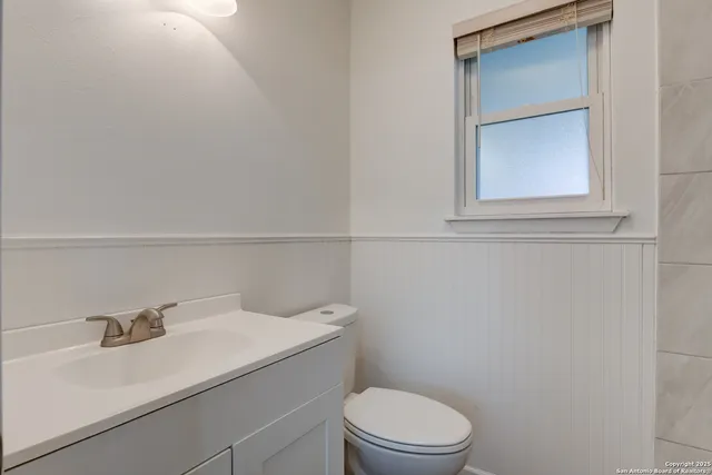 a bathroom with a sink a toilet and vanity