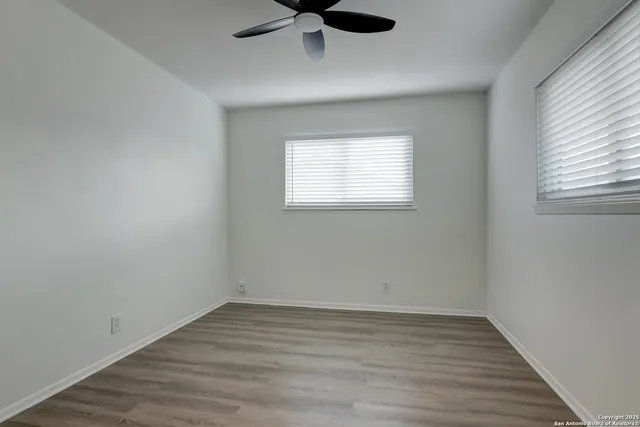 wooden floor in an empty room with a window