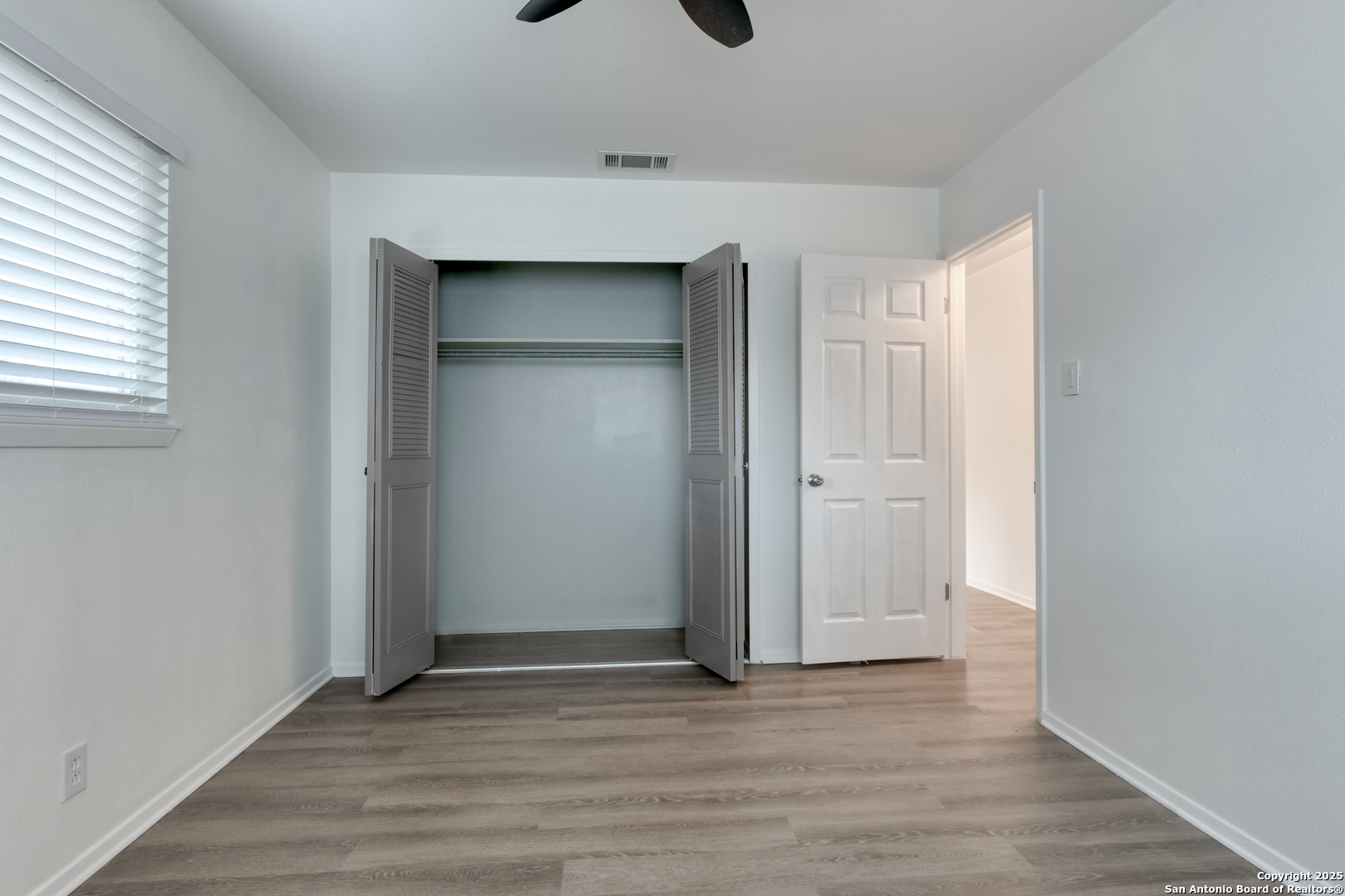 1044 Richmond Drive Schertz, TX 78154 - Photo 15 of 23 an empty room with wooden floor & closet area