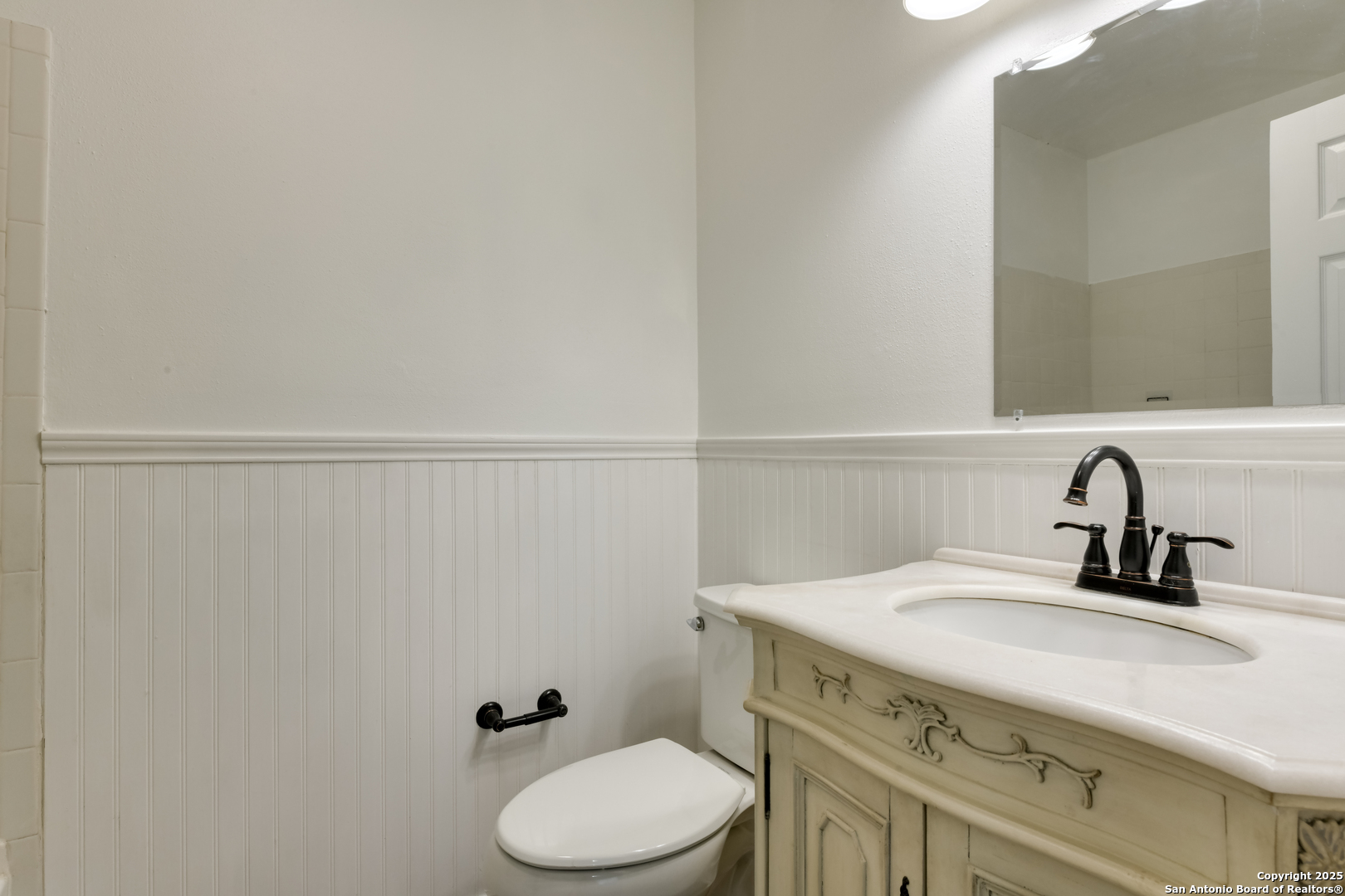 1044 Richmond Drive Schertz, TX 78154 - Photo 17 of 23 a bathroom with a sink a toilet and mirror