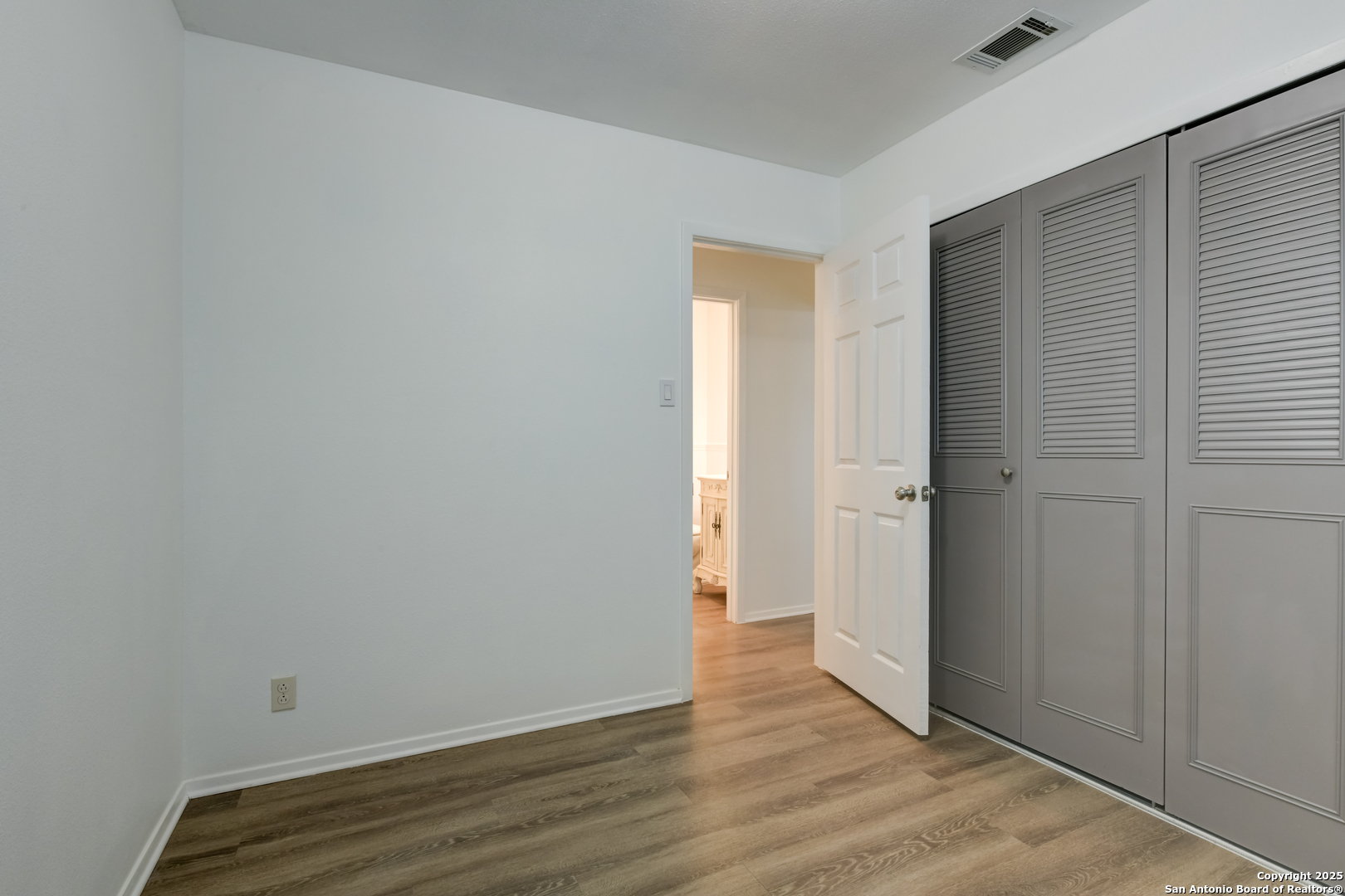 1044 Richmond Drive Schertz, TX 78154 - Photo 20 of 23 a view of an empty room with wooden floor