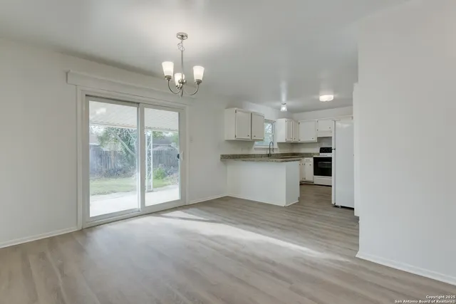 a view of a kitchen with a stove cabinets and a wooden floor