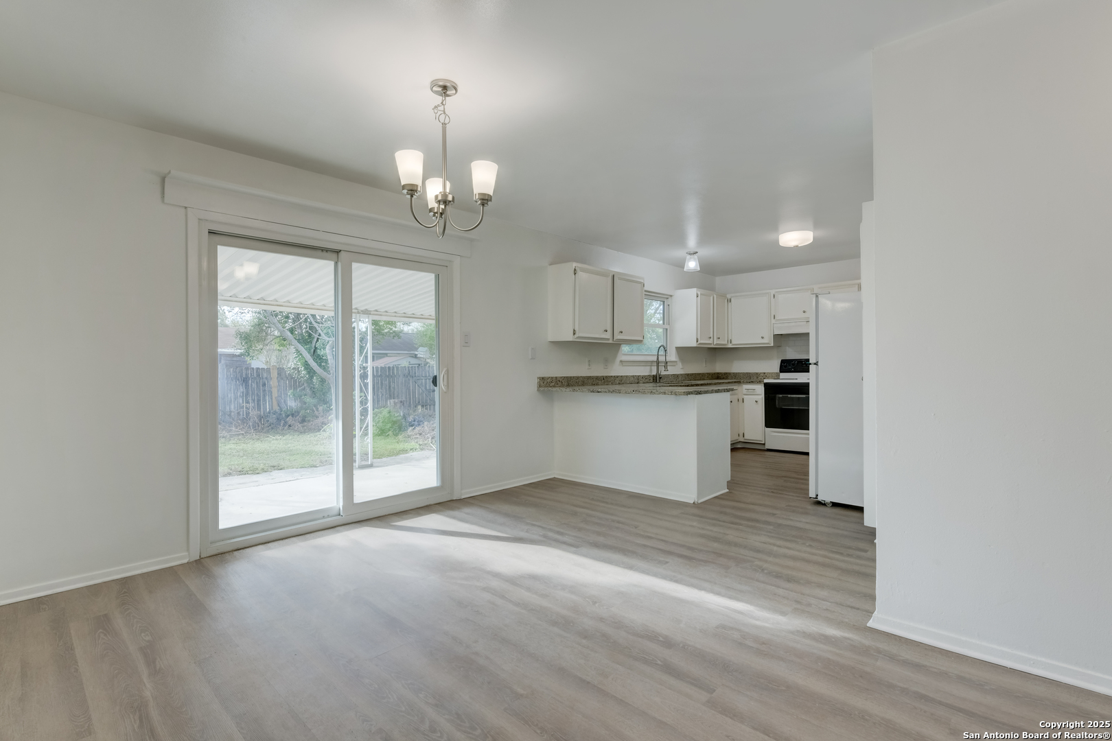 1044 Richmond Drive Schertz, TX 78154 - Photo 6 of 23 a view of a kitchen with a stove cabinets and a wooden floor