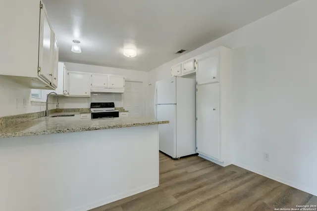 a kitchen with stainless steel appliances a refrigerator sink and cabinets