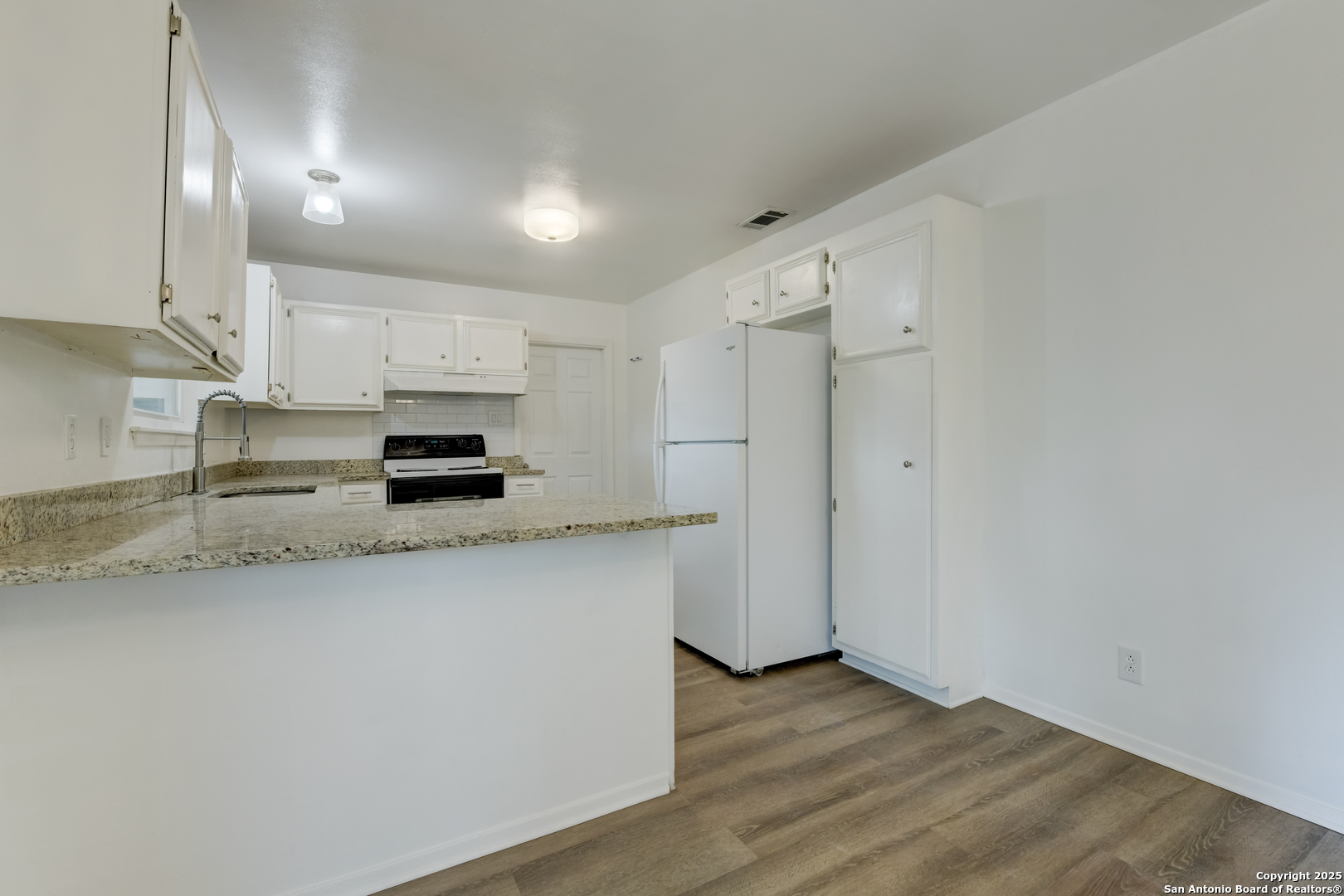 1044 Richmond Drive Schertz, TX 78154 - Photo 8 of 23 a kitchen with stainless steel appliances a refrigerator sink and cabinets