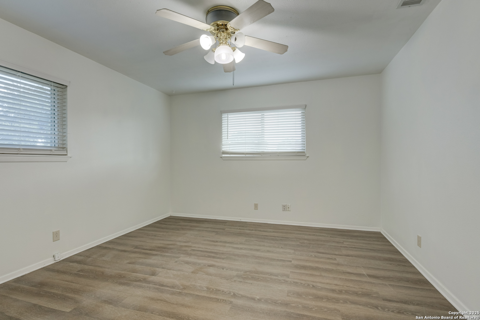 1044 Richmond Drive Schertz, TX 78154 - Photo 10 of 23 wooden floor in an empty room with a window