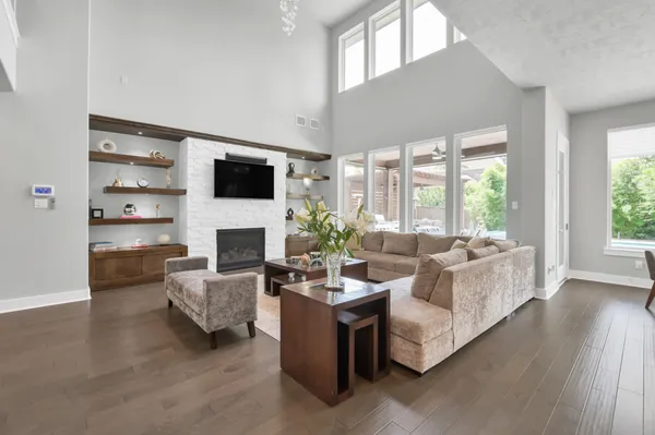 a living room with furniture fireplace and flat screen tv