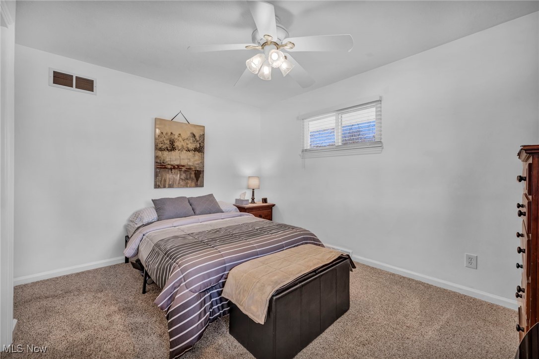 475 Harris Road Cleveland, OH 44143 - Photo 35 of 38 Bedroom with a ceiling fan, baseboards, visible vents, and carpet floors