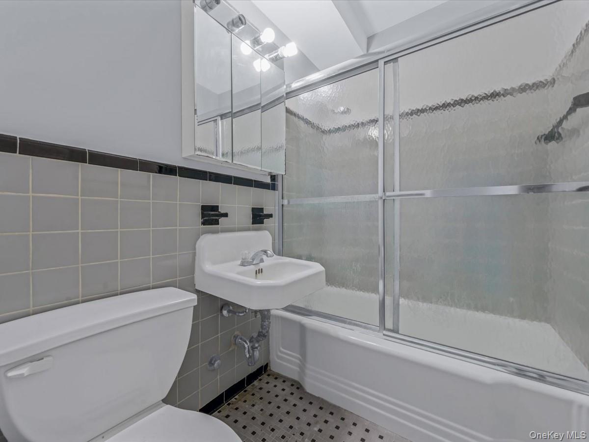 5500 Fieldston Road, Unit 4II Bronx, NY 10471 - Photo 11 of 17 a bathroom with a sink toilet and shower
