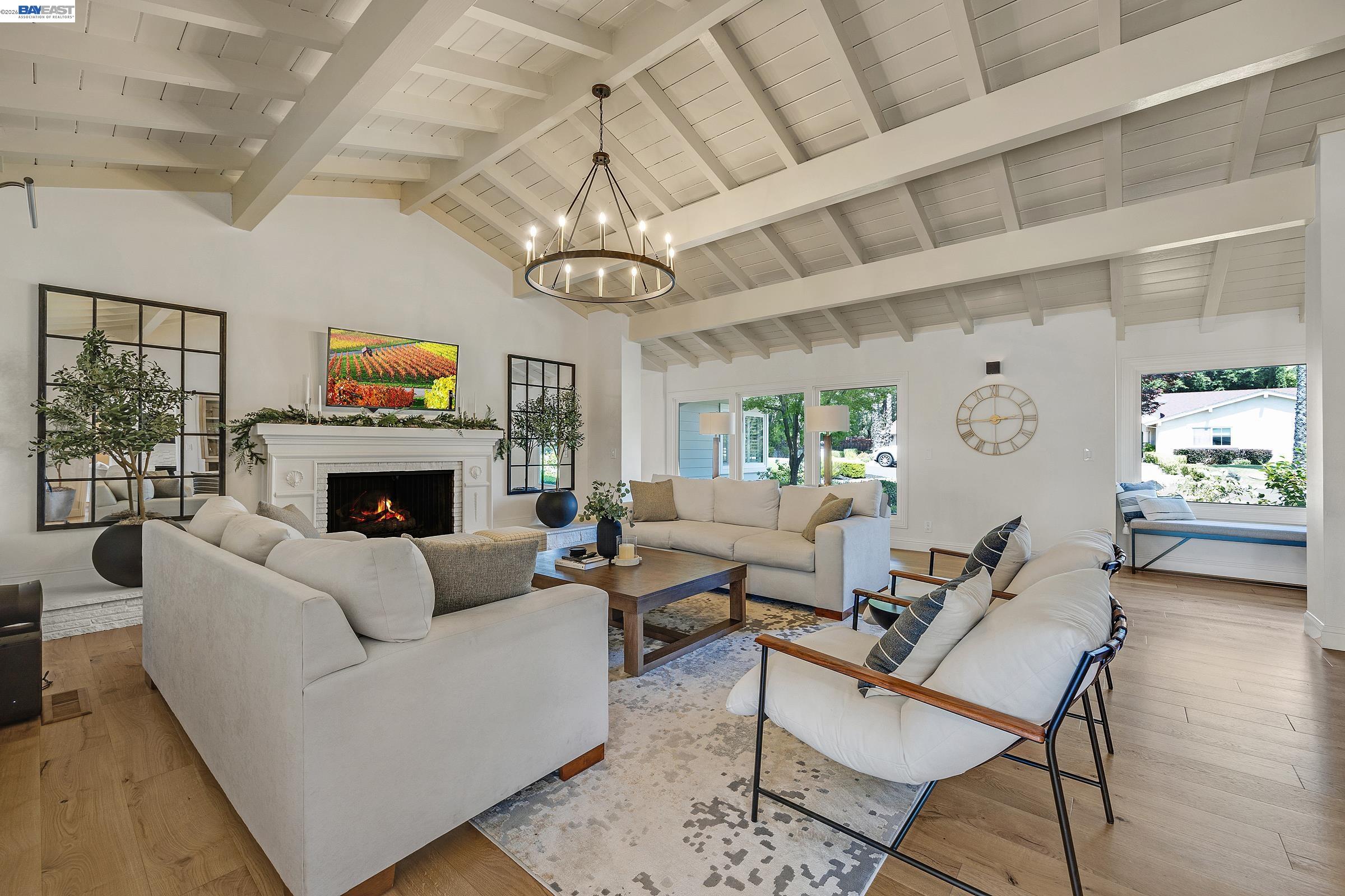 3144 Roundhill Road Alamo, CA 94507 - Photo 20 of 60 a living room with furniture a fireplace and a chandelier