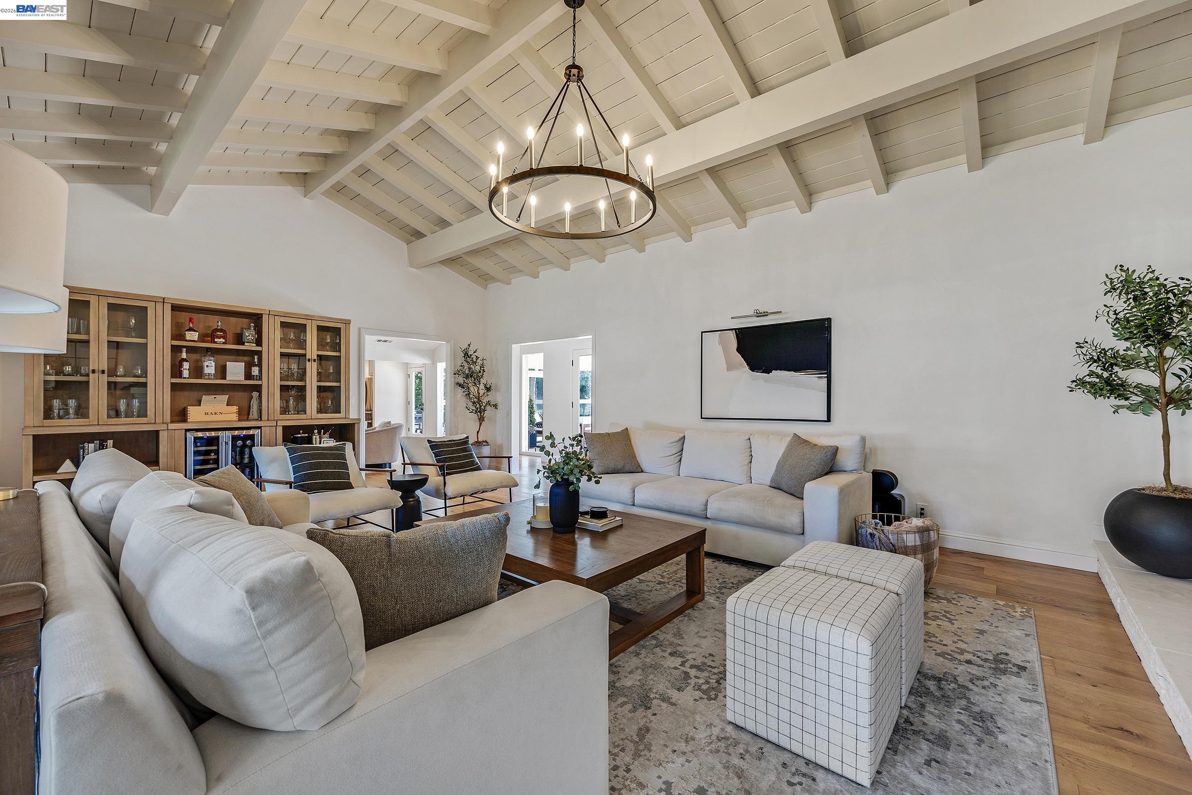 3144 Roundhill Road Alamo, CA 94507 - Photo 23 of 60 a living room with furniture a rug and a chandelier