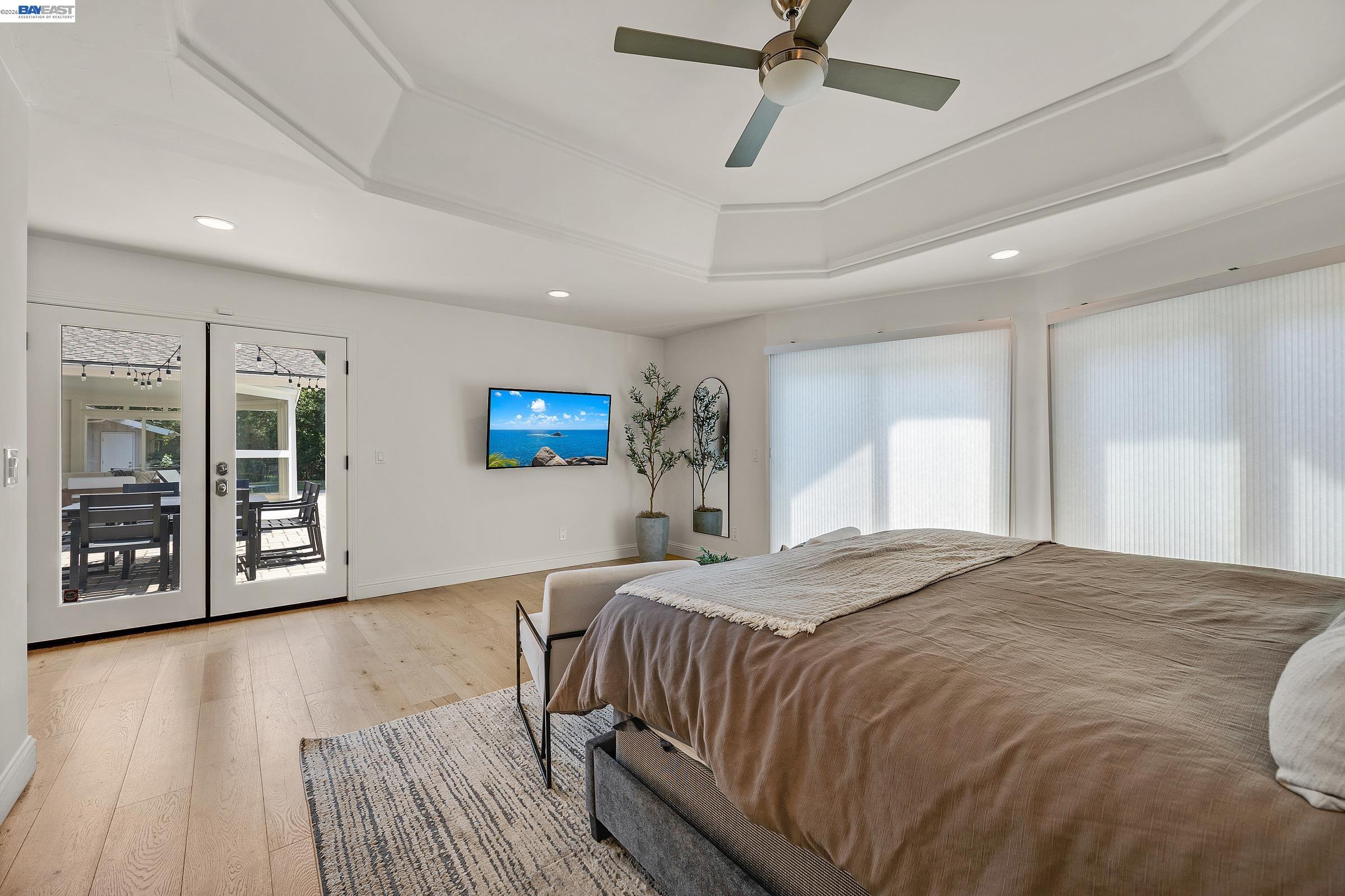 3144 Roundhill Road Alamo, CA 94507 - Photo 27 of 60 a spacious bedroom with a bed and a wooden floor
