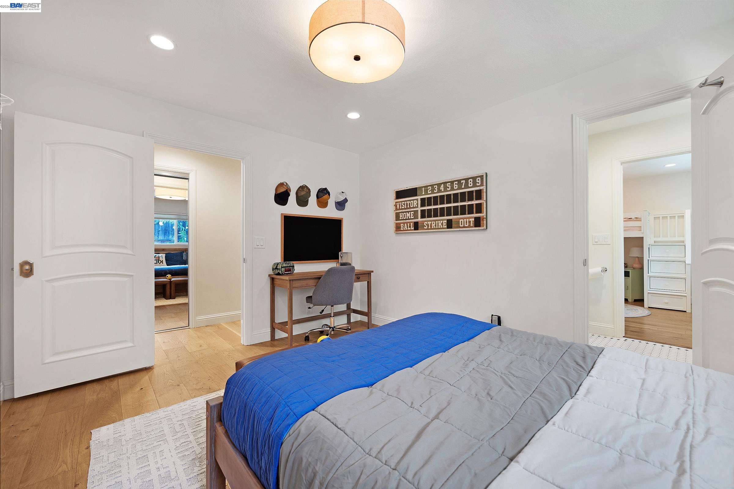3144 Roundhill Road Alamo, CA 94507 - Photo 36 of 60 a bedroom with a bed and a flat screen tv