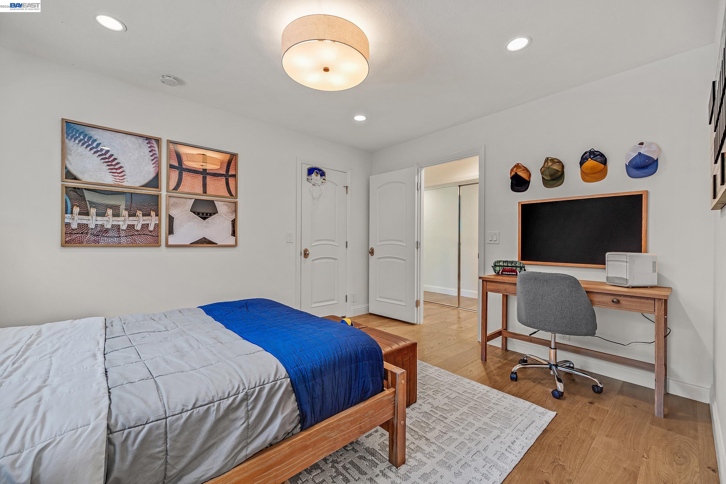 3144 Roundhill Road Alamo, CA 94507 - Photo 37 of 60 a bedroom with a bed and a flat screen tv