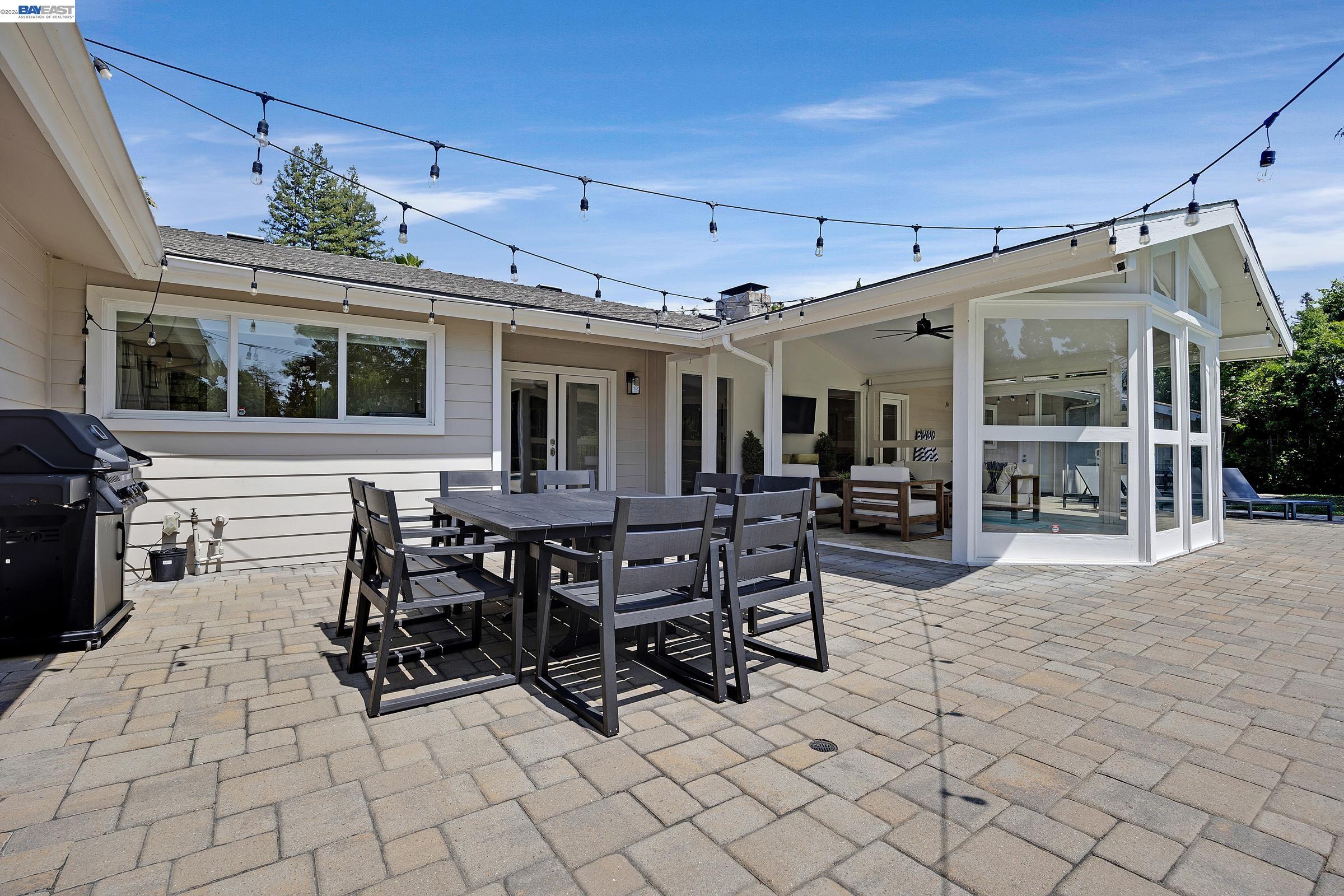 3144 Roundhill Road Alamo, CA 94507 - Photo 47 of 60 a view of a patio with table and chairs potted plants and floor to ceiling window