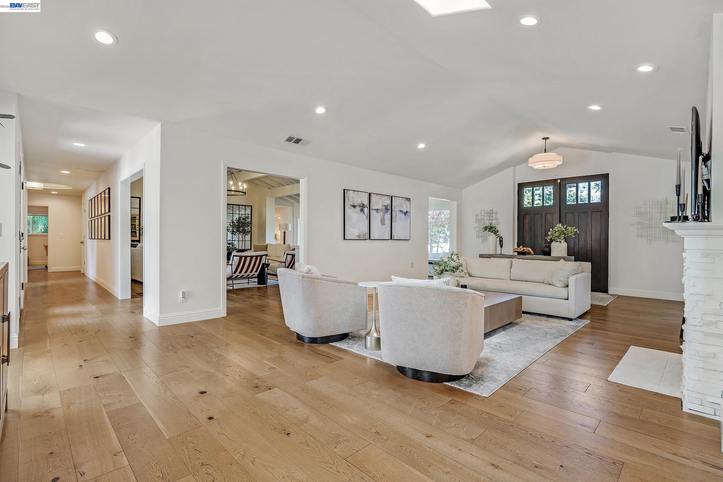 3144 Roundhill Road Alamo, CA 94507 - Photo 5 of 60 a living room with couches and kitchen view with wooden floor