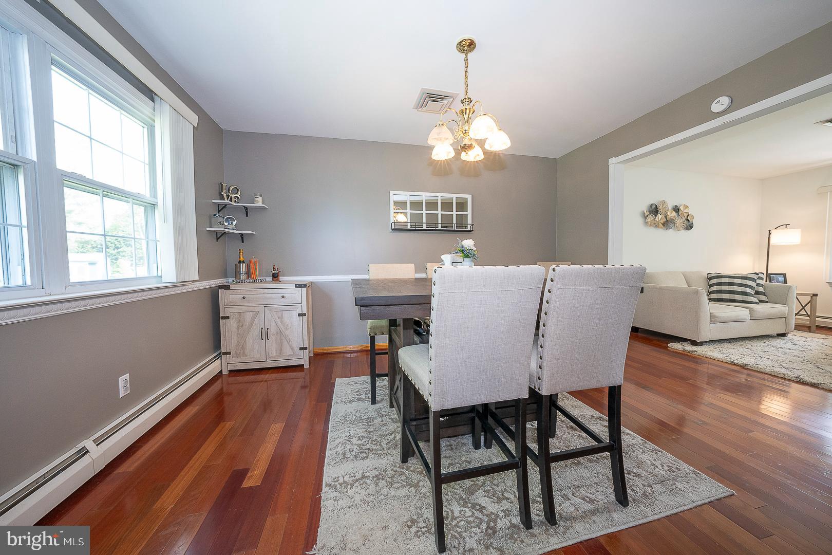 70 Hidden Valley Road Aston, PA 19014 - Photo 13 of 62 a view of a dining room with furniture a chandelier and wooden floor