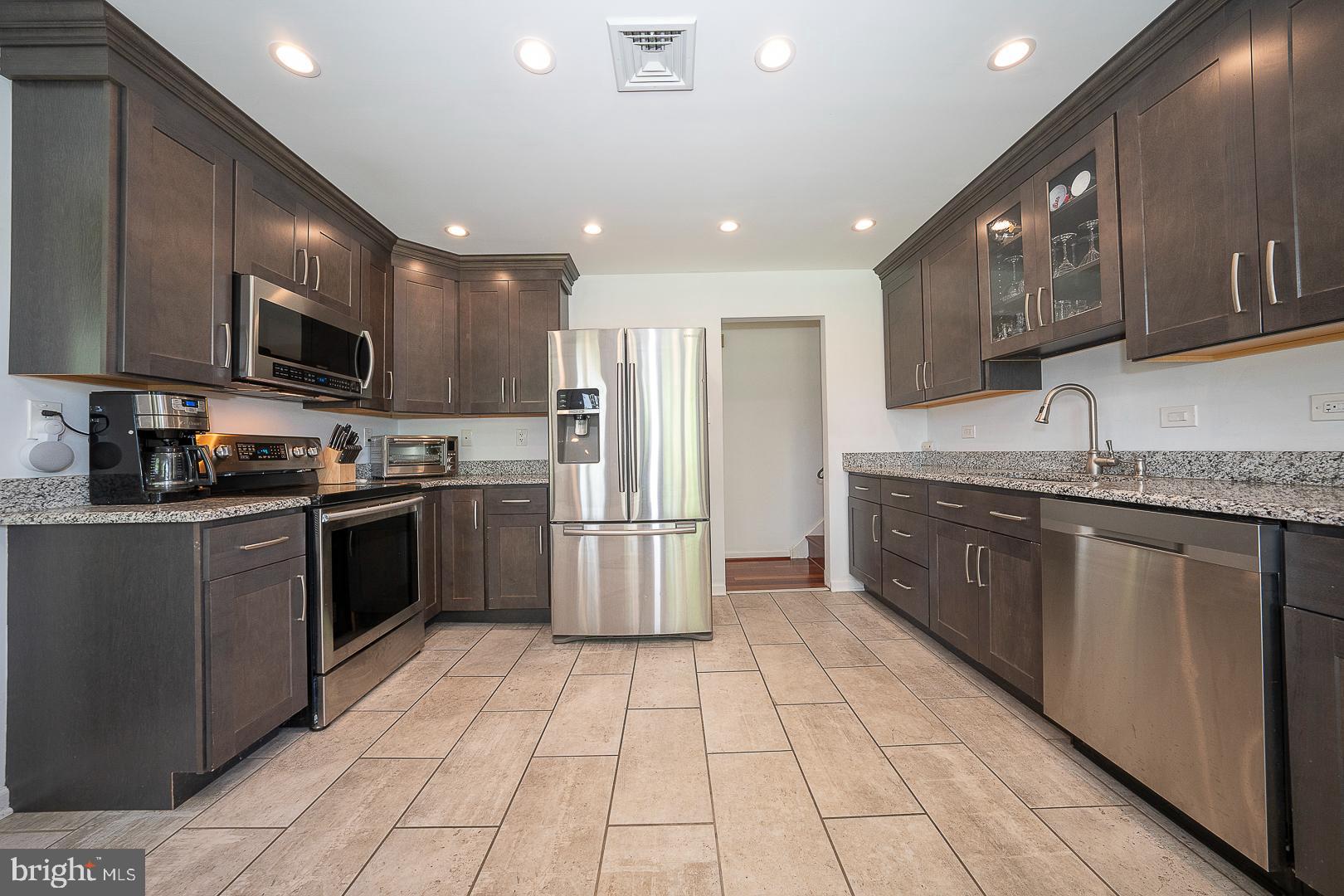 70 Hidden Valley Road Aston, PA 19014 - Photo 15 of 62 a kitchen with stainless steel appliances granite countertop a refrigerator a sink a stove a microwave and island