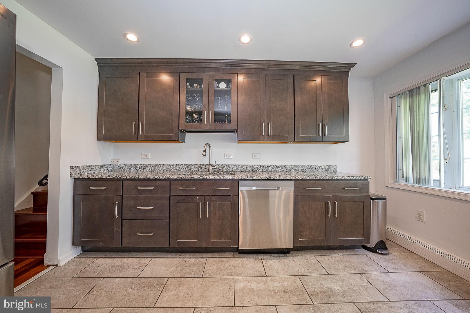 70 Hidden Valley Road Aston, PA 19014 - Photo 16 of 62 a spacious bathroom with a granite countertop sink and a mirror