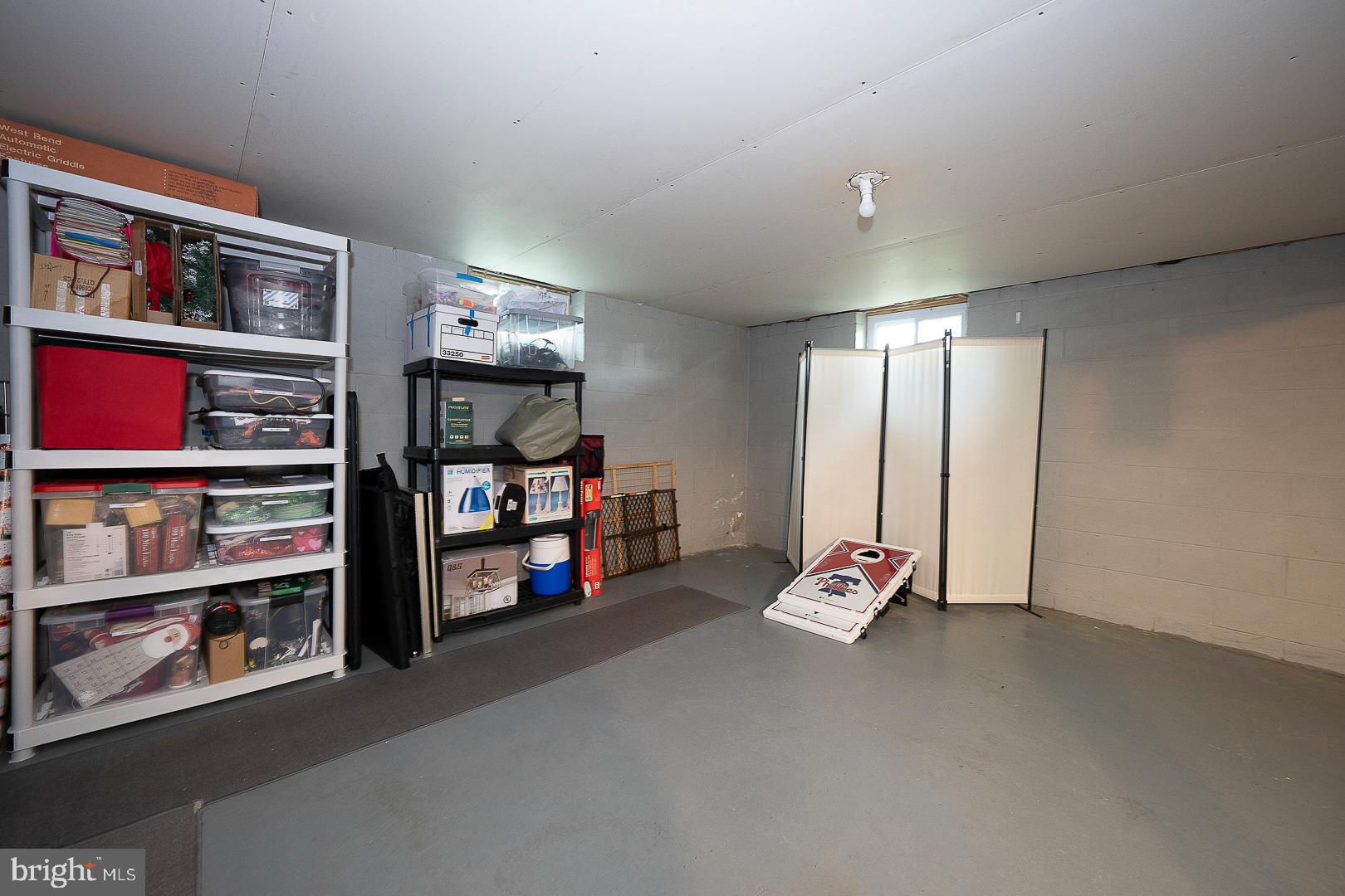 70 Hidden Valley Road Aston, PA 19014 - Photo 55 of 62 a room with lots of white furniture and a book shelf