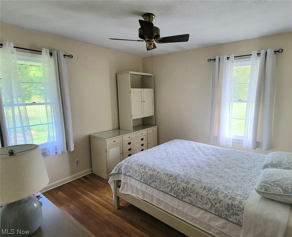 6416 Milan Road Sandusky, OH 44870 - Photo 21 of 34 Bedroom featuring multiple windows, ceiling fan, and hardwood flooring