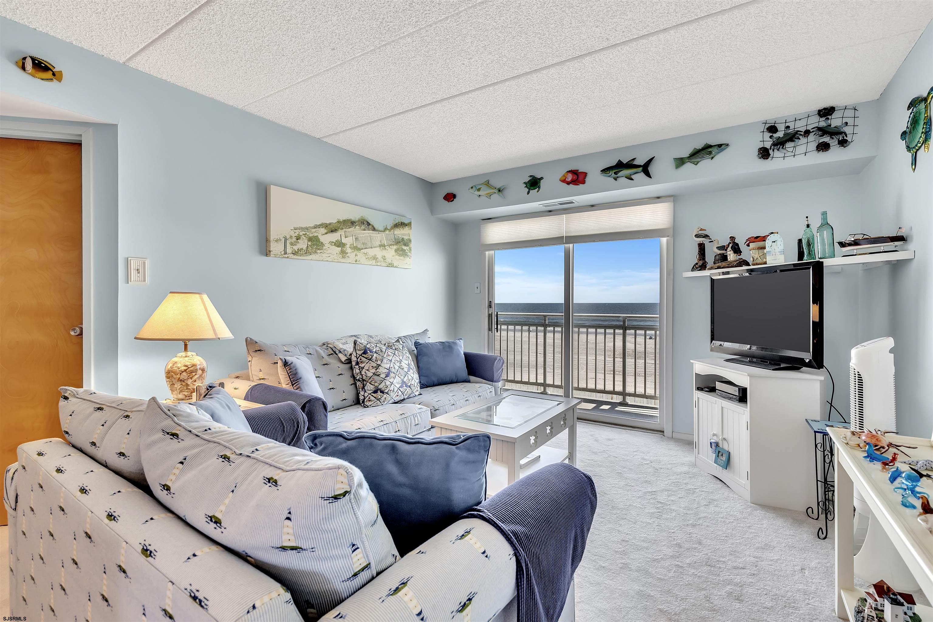 700 East Brigantine Avenue, Unit 2B Brigantine, NJ 08203 - Photo 12 of 36 a living room with furniture a flat screen tv and a window