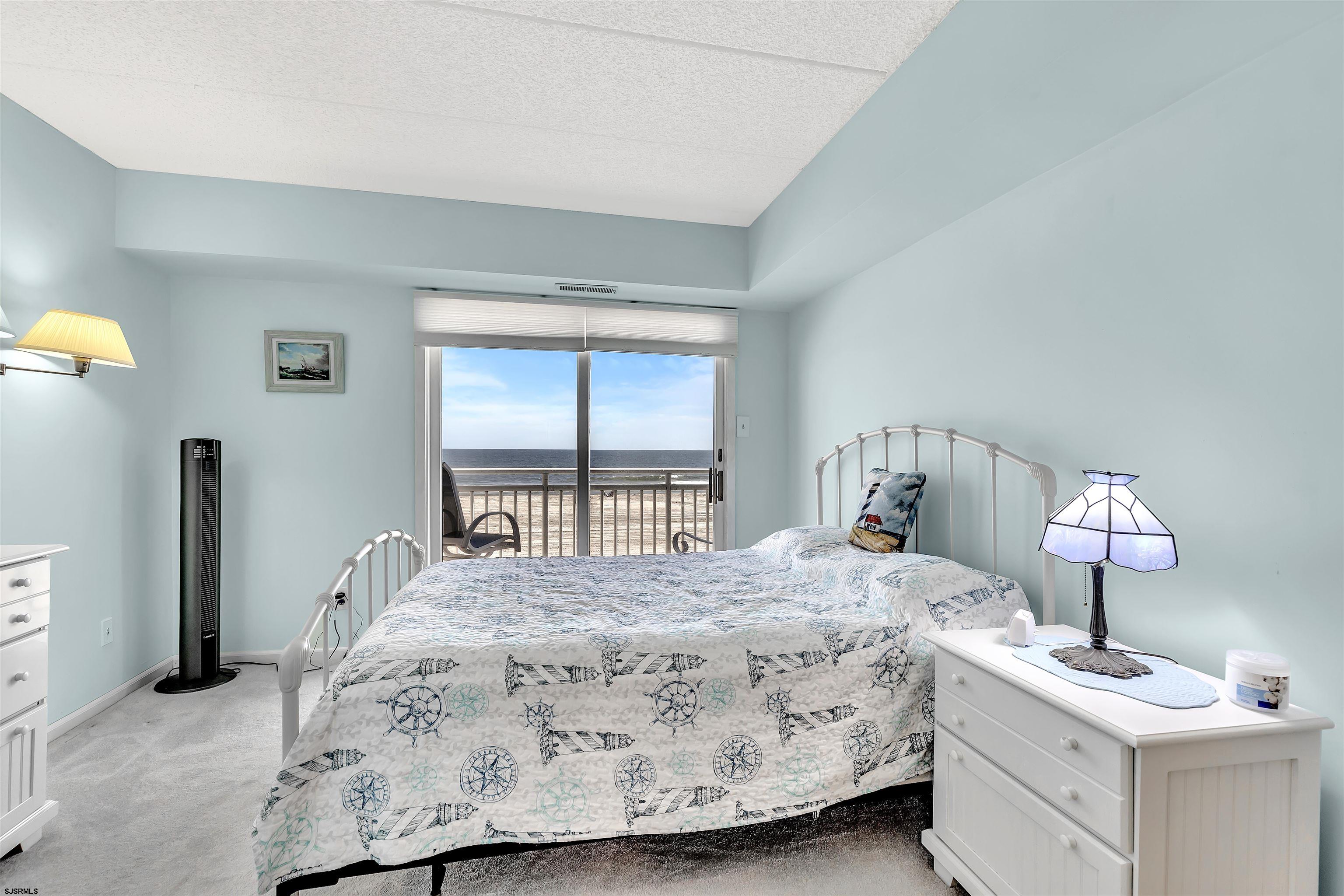 700 East Brigantine Avenue, Unit 2B Brigantine, NJ 08203 - Photo 19 of 36 a bedroom with a bed and window with lamp