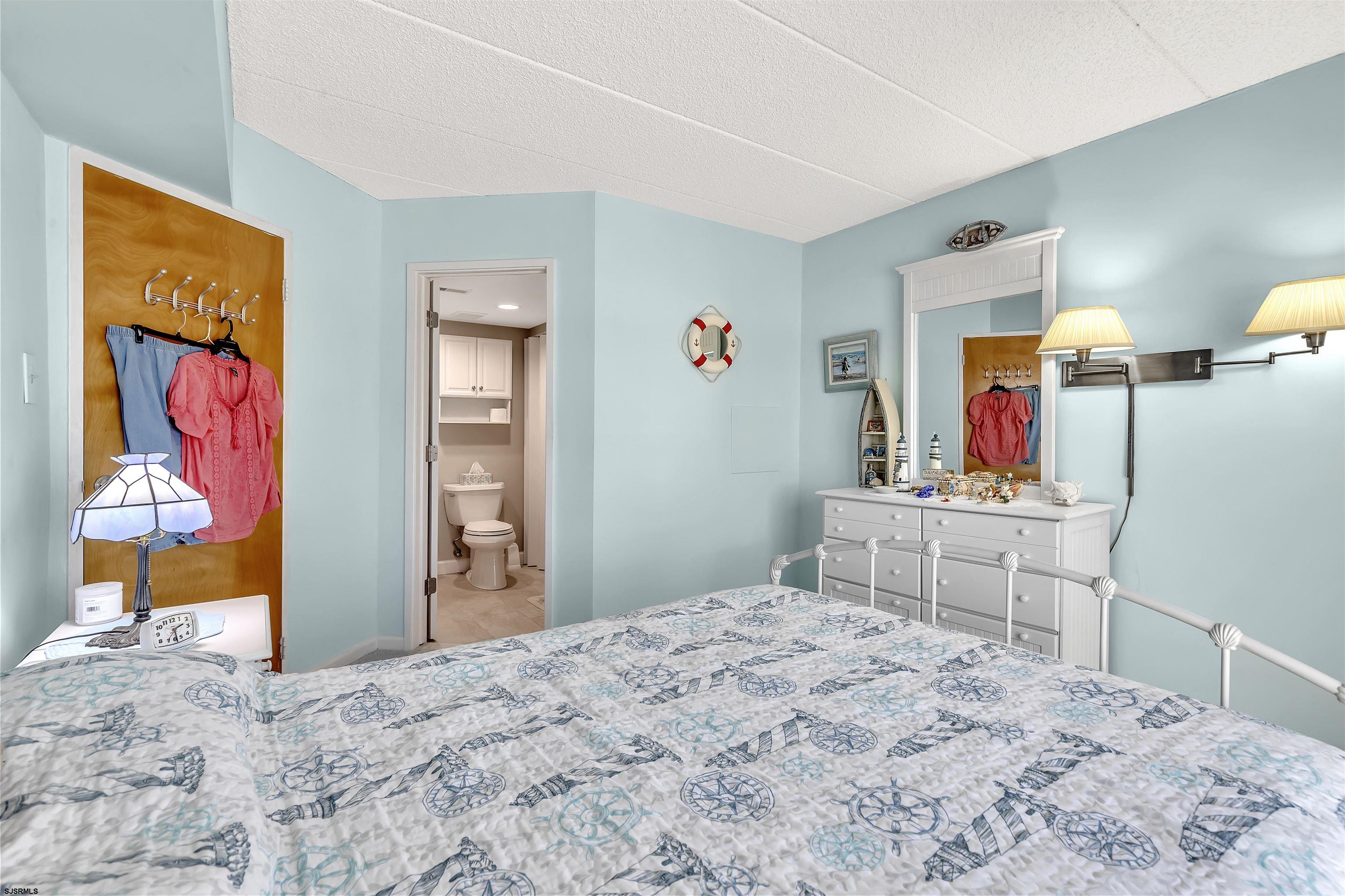 700 East Brigantine Avenue, Unit 2B Brigantine, NJ 08203 - Photo 20 of 36 a bedroom with a bed and a dresser in it