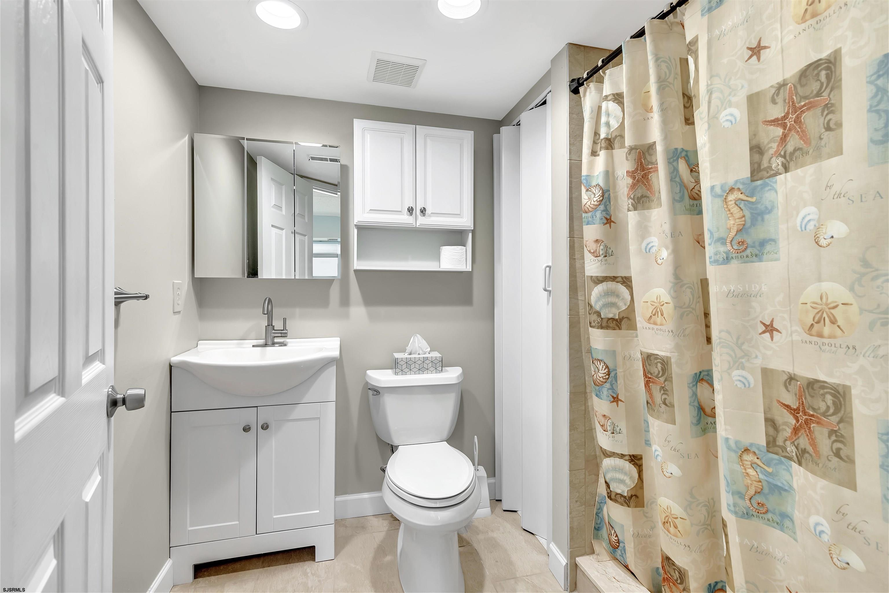700 East Brigantine Avenue, Unit 2B Brigantine, NJ 08203 - Photo 21 of 36 a bathroom with a toilet sink and mirror