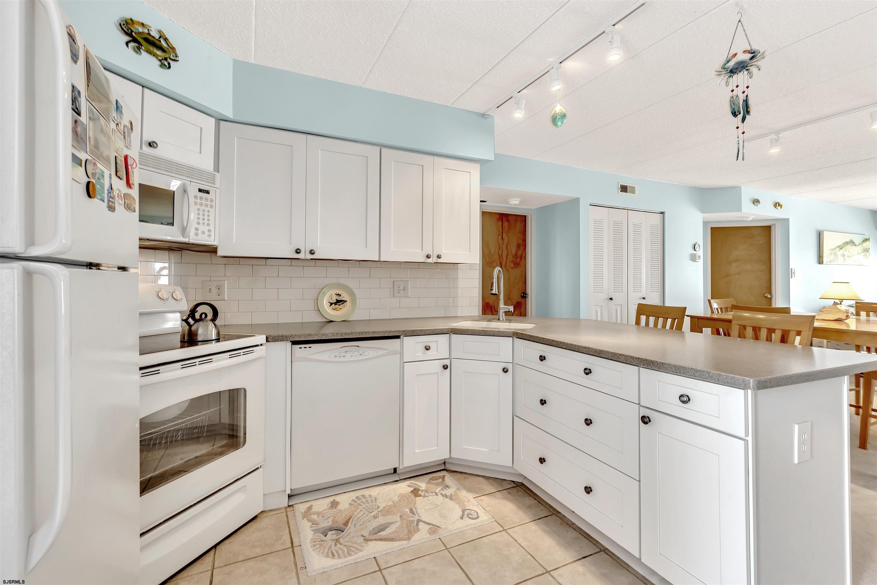 700 East Brigantine Avenue, Unit 2B Brigantine, NJ 08203 - Photo 3 of 36 a kitchen with cabinets appliances and a window