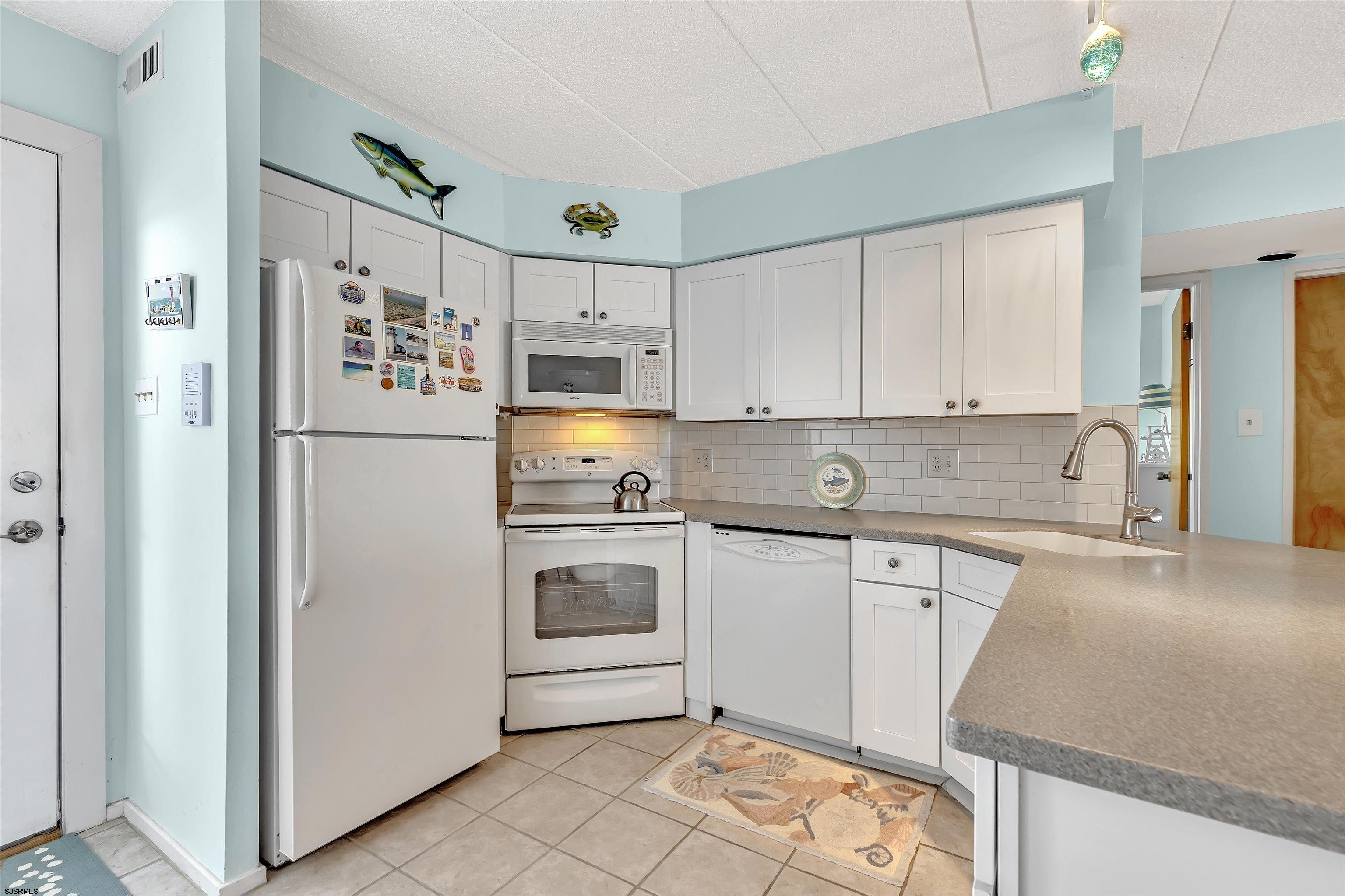 700 East Brigantine Avenue, Unit 2B Brigantine, NJ 08203 - Photo 6 of 36 a kitchen with stainless steel appliances granite countertop a refrigerator sink and stove