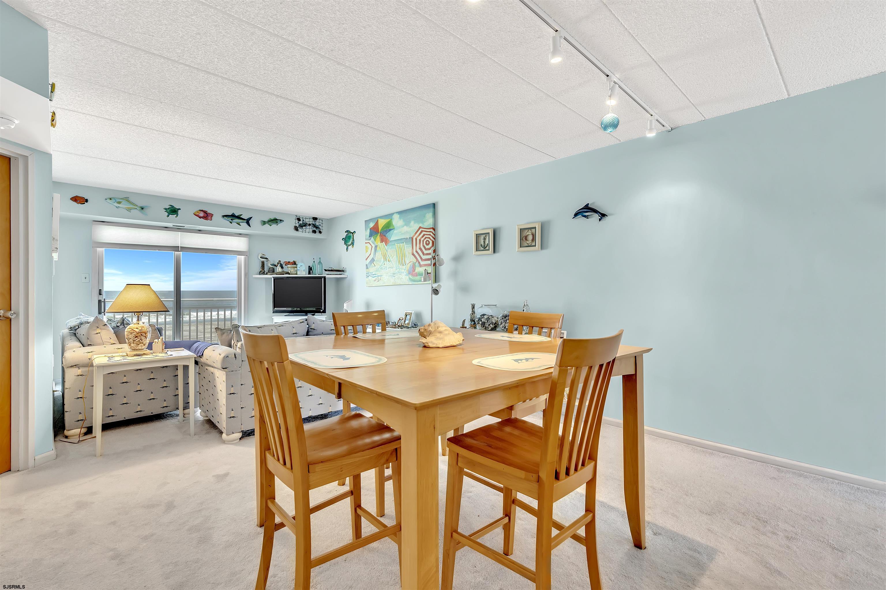 700 East Brigantine Avenue, Unit 2B Brigantine, NJ 08203 - Photo 10 of 36 a view of a dining room with furniture and chandelier