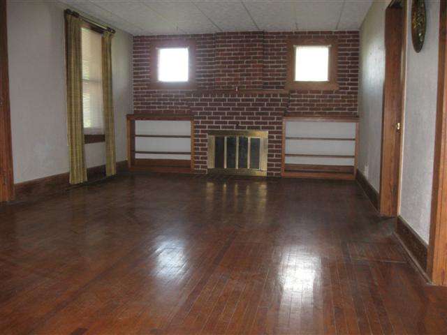 1077 North Henderson Road Freeport, IL 61032 - Photo 8 of 12 a view of a livingroom with wooden floor and an entryway