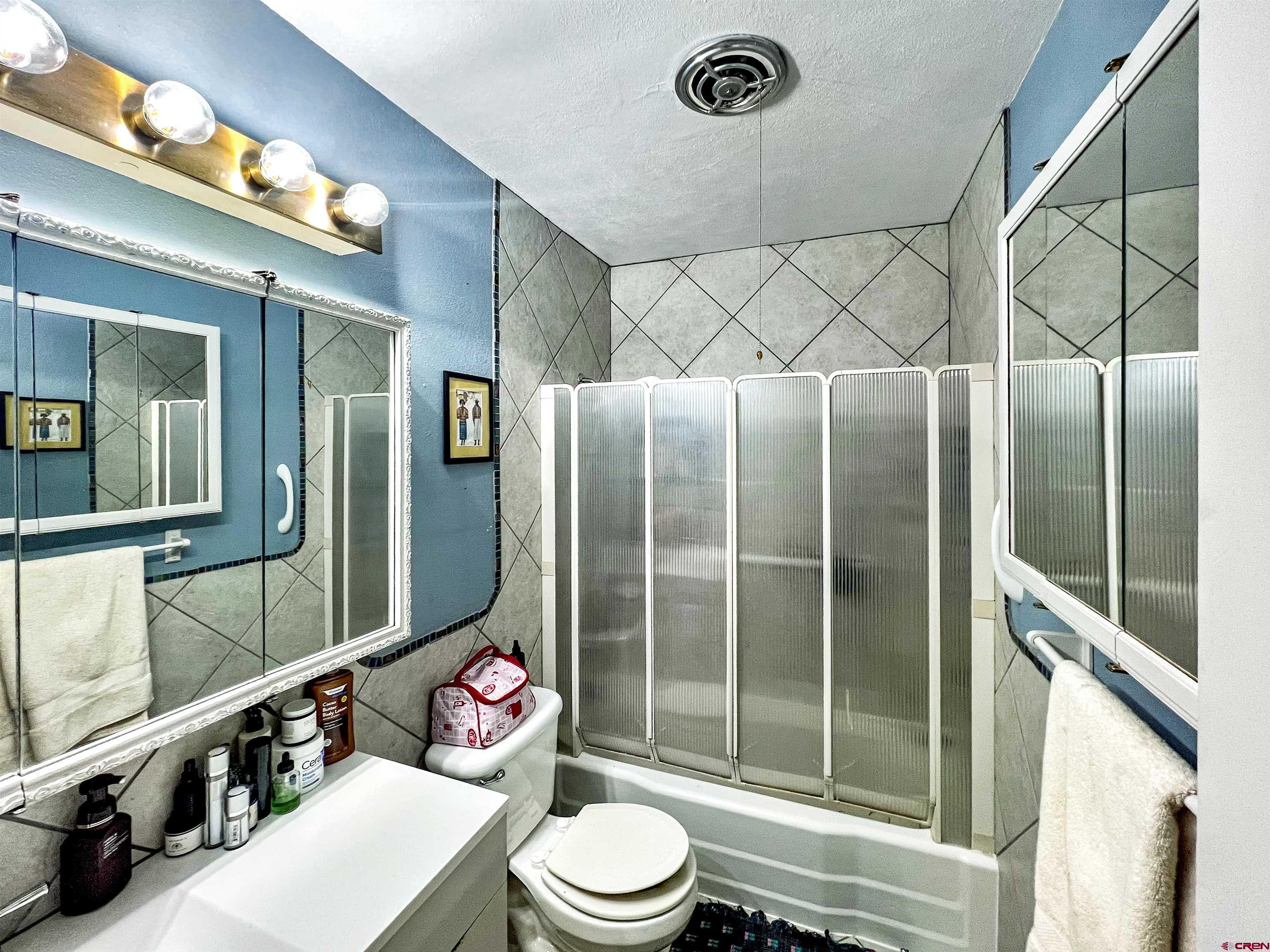 1005 South Cedar Street Cortez, CO 81321 - Photo 15 of 19 a bathroom with a sink a toilet and shower