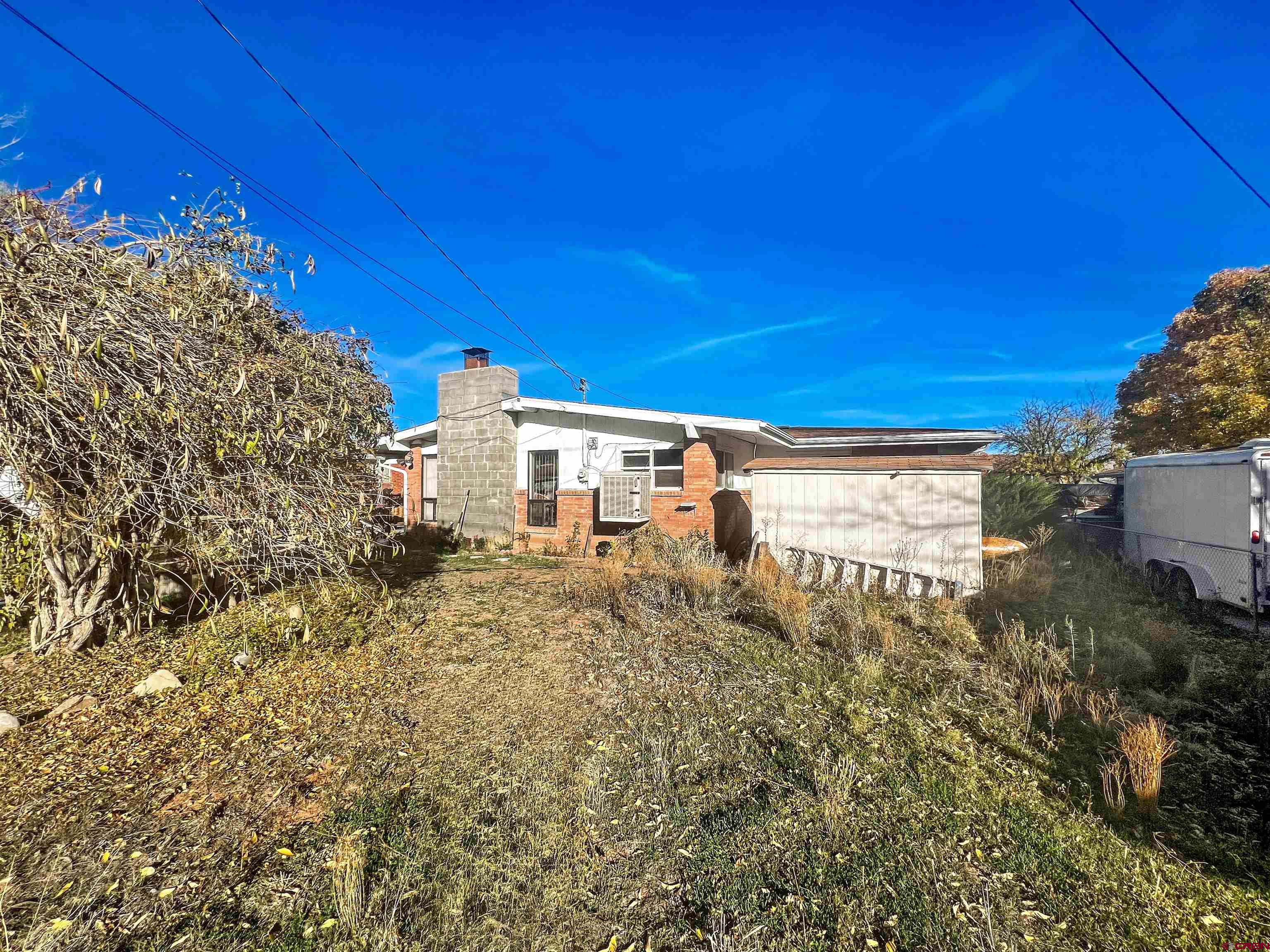 1005 South Cedar Street Cortez, CO 81321 - Photo 16 of 19 a view of a house with a yard