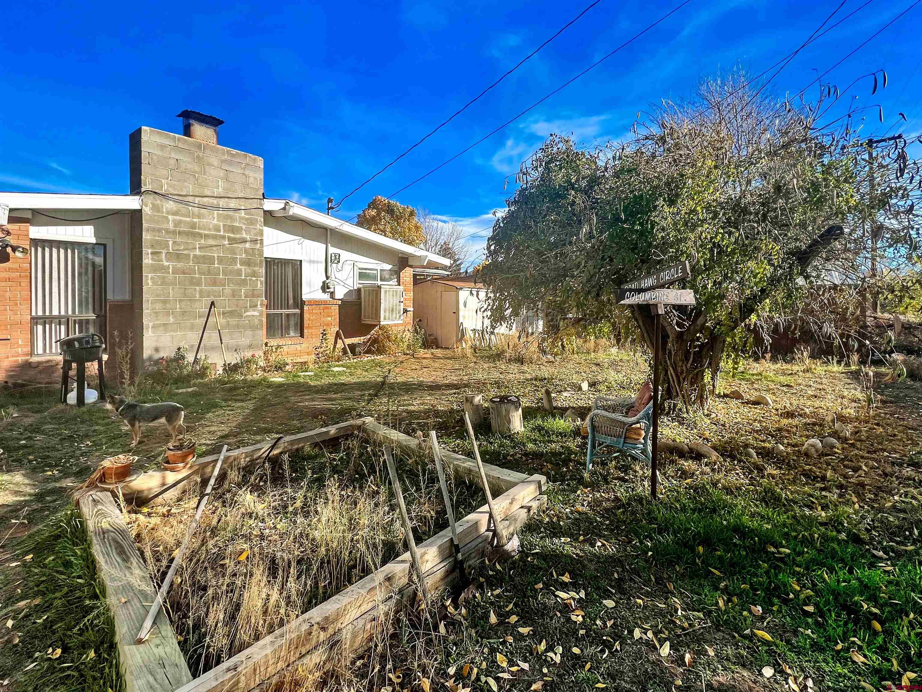 1005 South Cedar Street Cortez, CO 81321 - Photo 17 of 19 a view of multiple house with yard and seating area