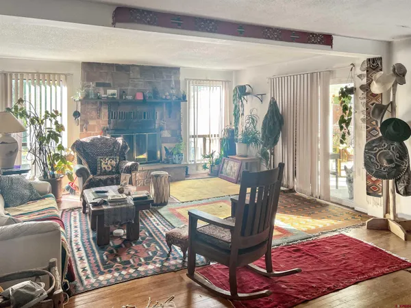 a room with stainless steel appliances kitchen island granite countertop a refrigerator and a sink