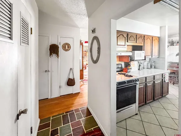 a large kitchen with stainless steel appliances sink stove and cabinets