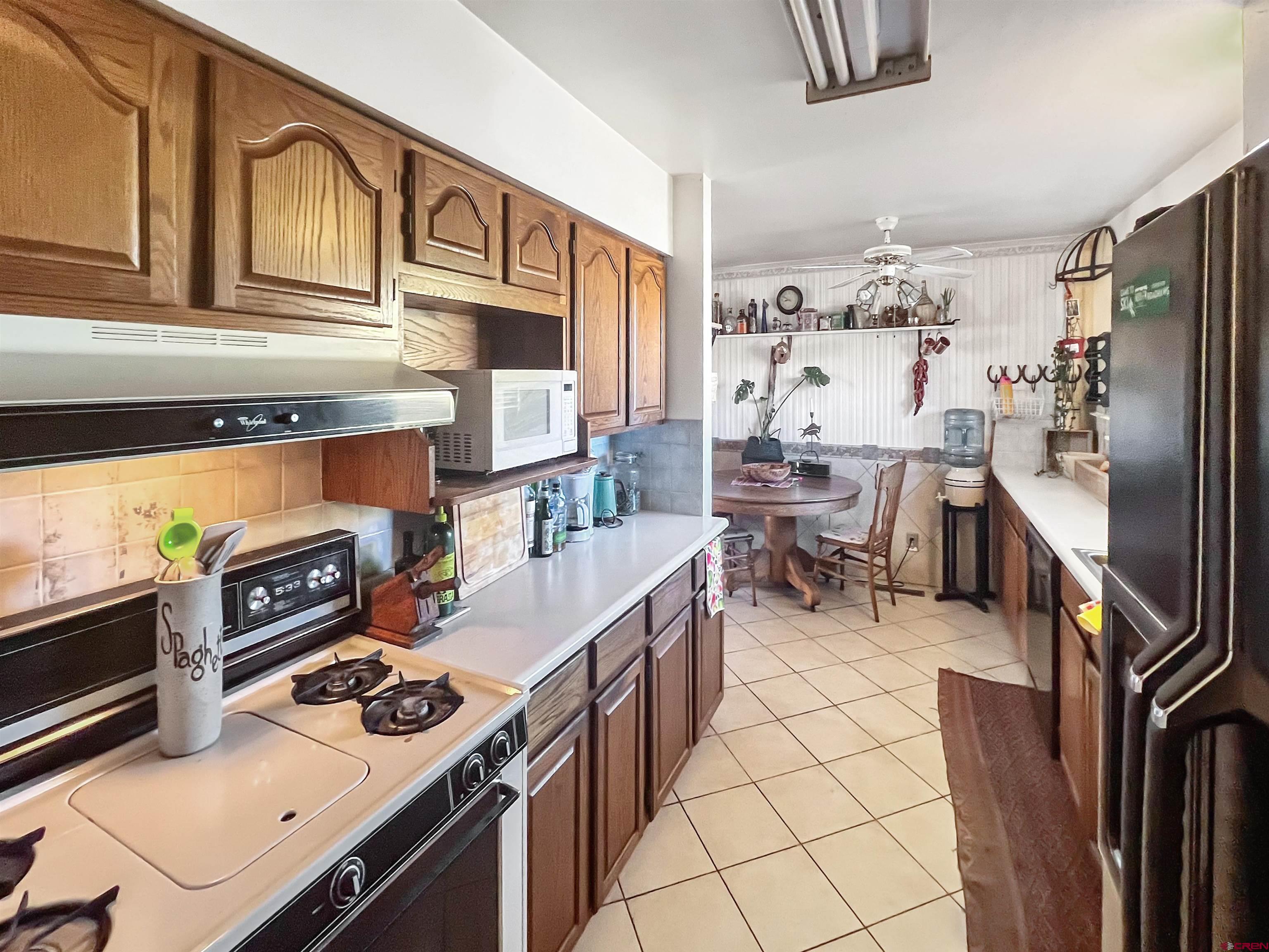 1005 South Cedar Street Cortez, CO 81321 - Photo 7 of 19 a kitchen with stainless steel appliances a stove a sink and a refrigerator