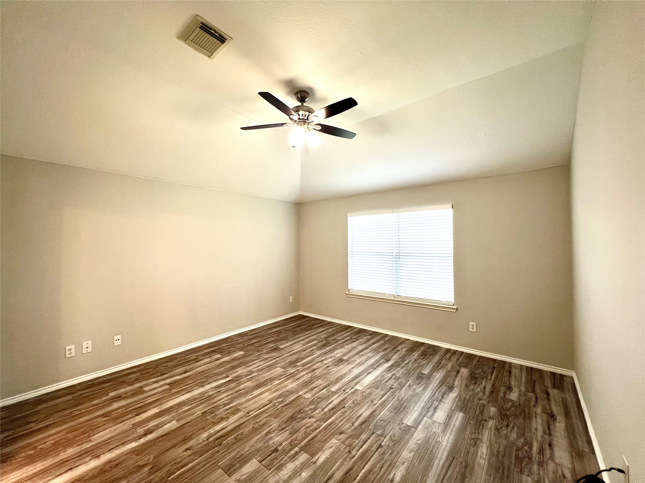 4414 Kulkarni Street Houston, TX 77045 - Photo 13 of 18 an empty room with a window and a ceiling fan