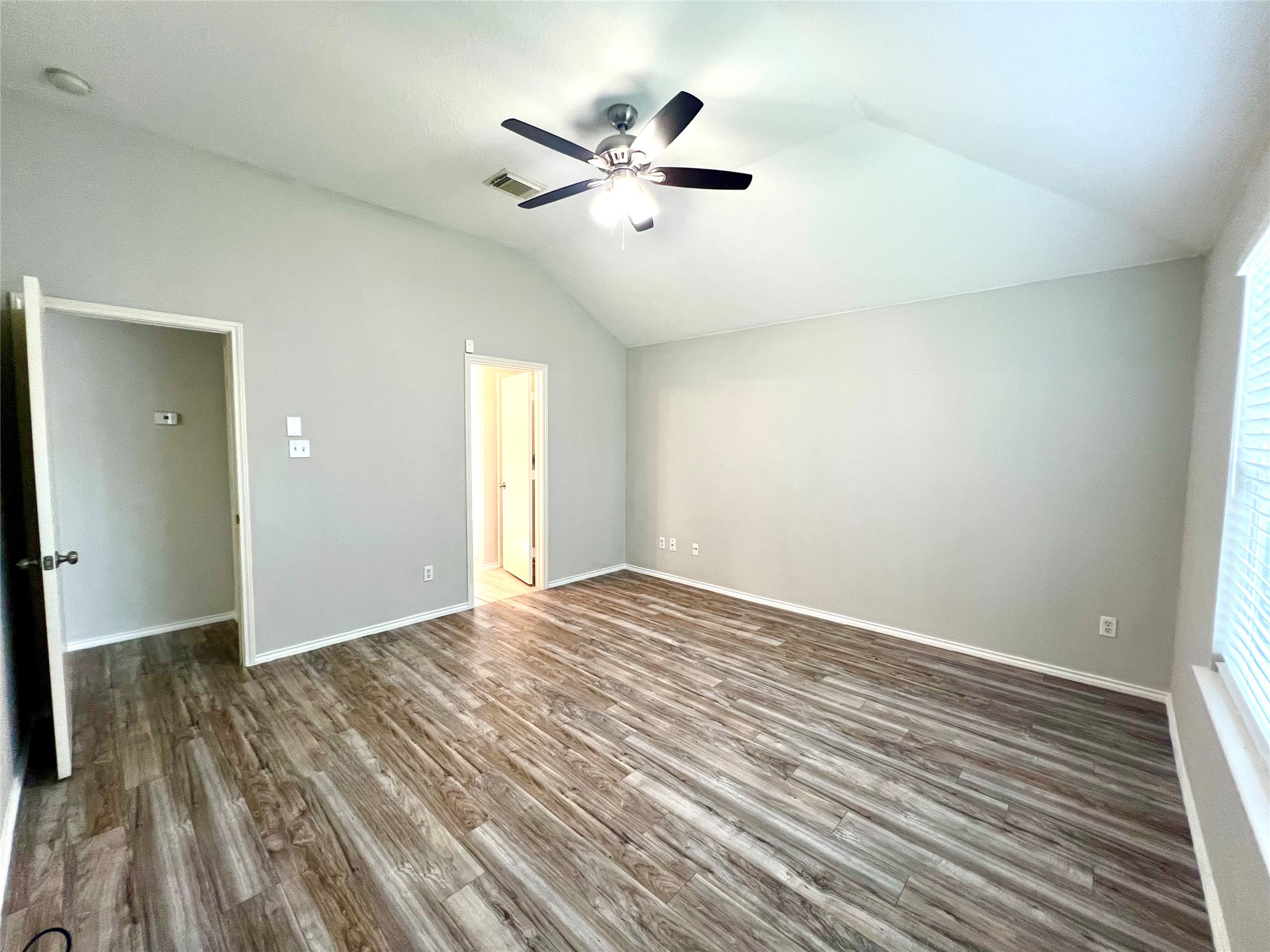 4414 Kulkarni Street Houston, TX 77045 - Photo 14 of 18 an empty room with wooden floor and ceiling fan