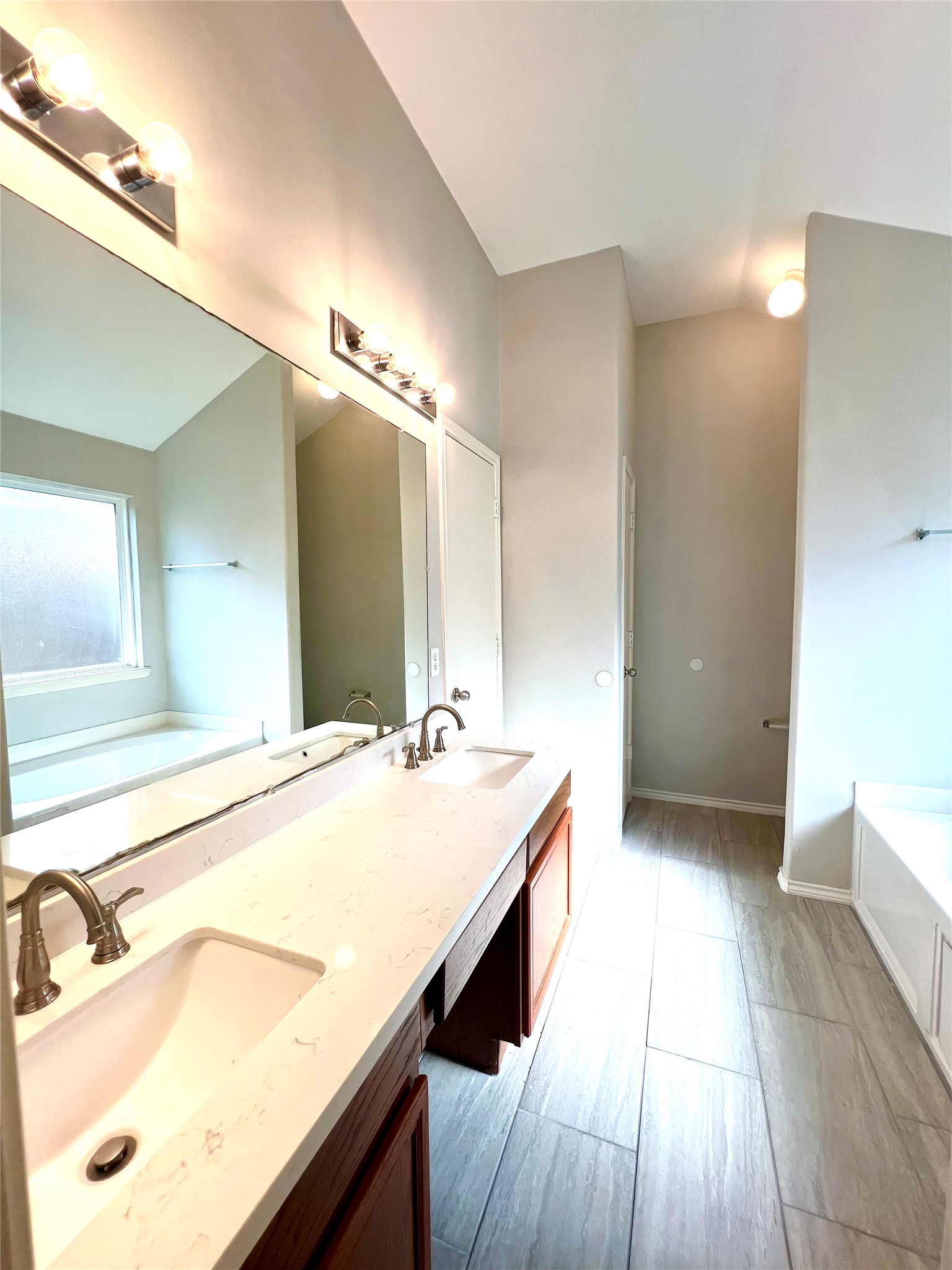 4414 Kulkarni Street Houston, TX 77045 - Photo 15 of 18 a bathroom with a sink and a mirror