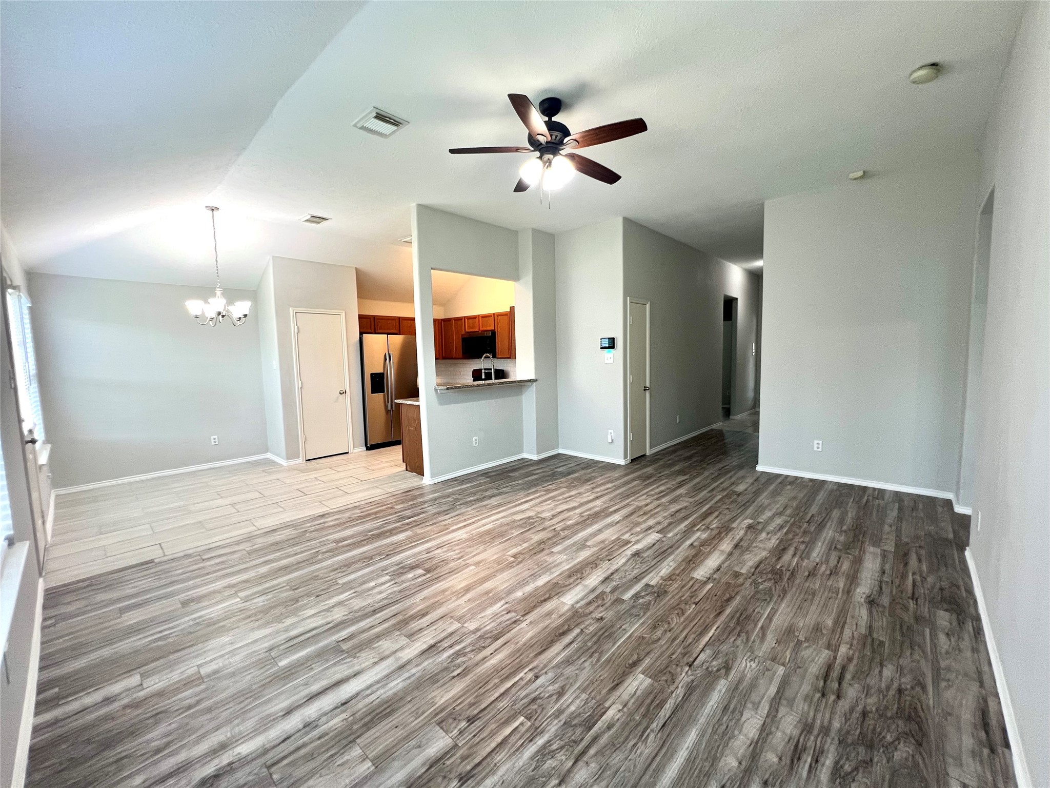 4414 Kulkarni Street Houston, TX 77045 - Photo 10 of 18 a view of empty room with wooden floor and fan