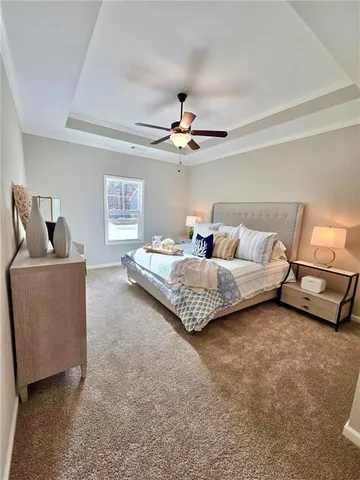 a living room with furniture and a ceiling fan