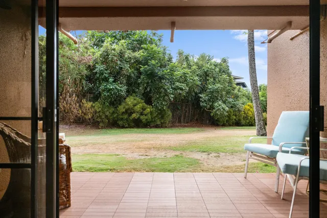 a view of a patio with table and chairs and potted plants with wooden floor