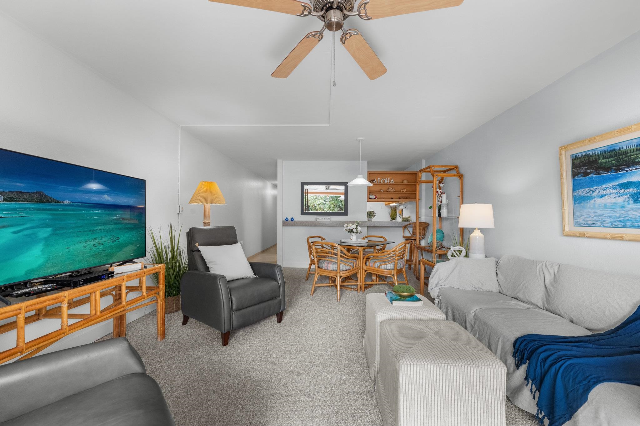 4242 Lower Honoapiilani Road, Unit E304 Lahaina, HI 96761 - Photo 2 of 34 a living room with furniture and a flat screen tv