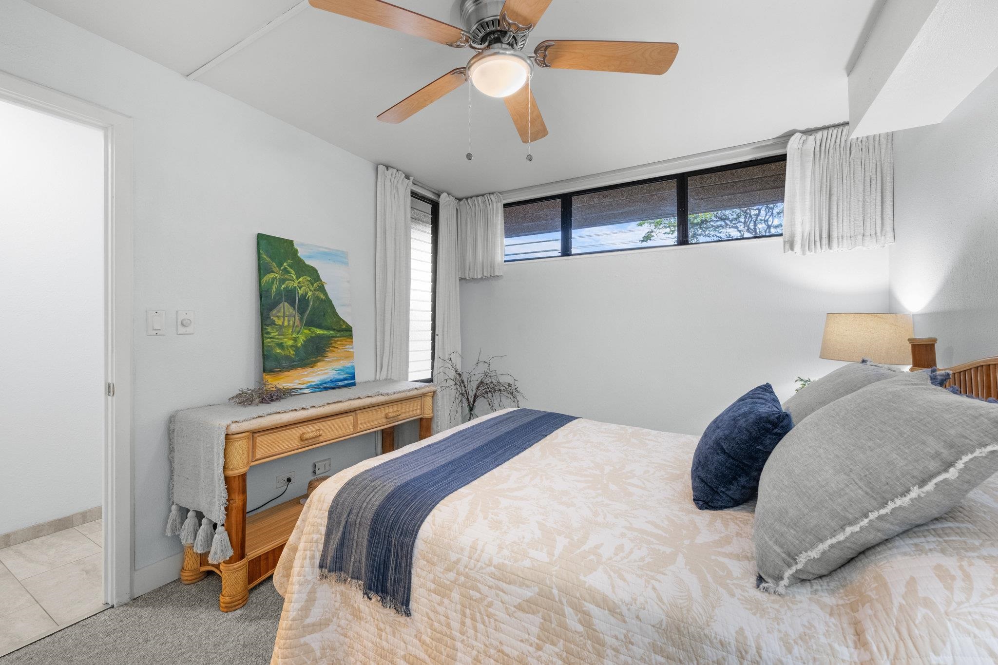 4242 Lower Honoapiilani Road, Unit E304 Lahaina, HI 96761 - Photo 21 of 34 a bedroom with a bed and a chandelier