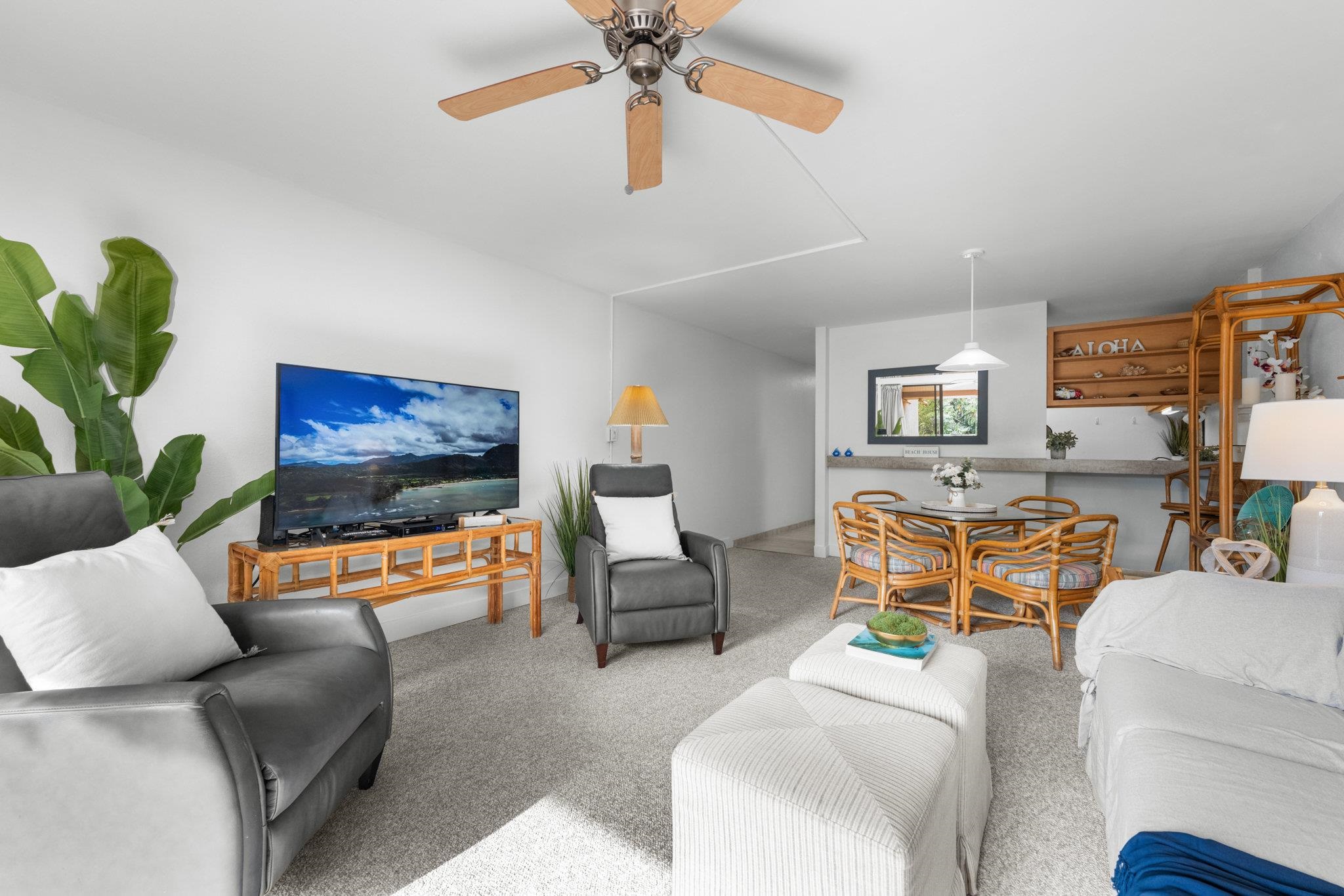 4242 Lower Honoapiilani Road, Unit E304 Lahaina, HI 96761 - Photo 7 of 34 a living room with furniture and a flat screen tv