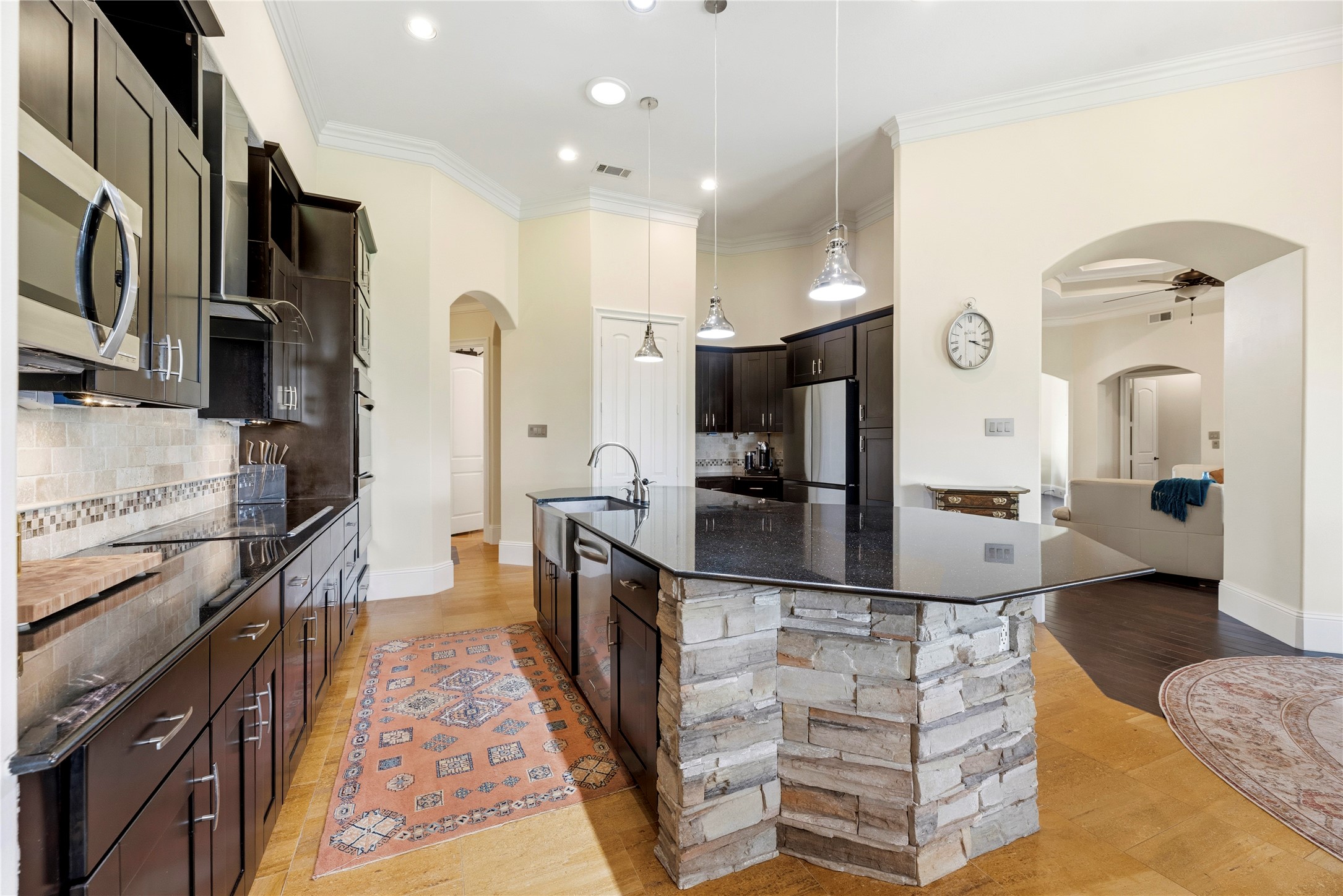 6306 Farm To Market 359 Fulshear, TX 77441 - Photo 14 of 44 This sophisticated kitchen showcases elegant soft-closing custom cabinetry and drawers, paired with professional under-cabinet lighting and an expansive walk-in pantry for the ultimate organization.