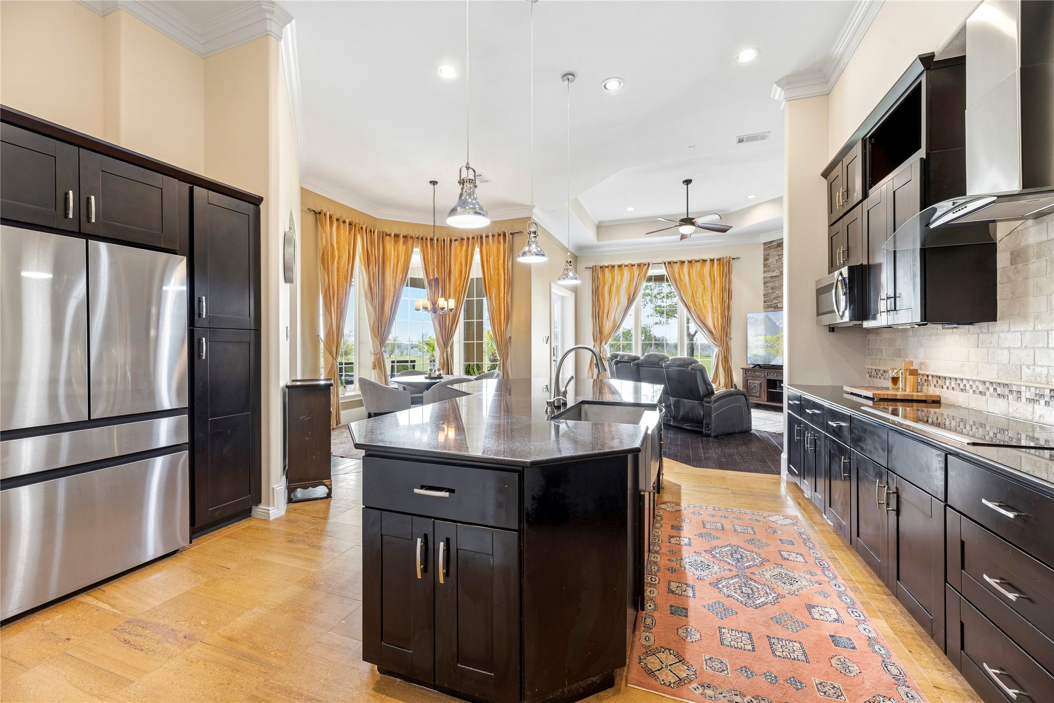 6306 Farm To Market 359 Fulshear, TX 77441 - Photo 15 of 44 This professional-grade kitchen features a stainless steel sink and elegant designer pendant lighting, highlighting the high-end finishes and meticulous craftsmanship found throughout the estate.
